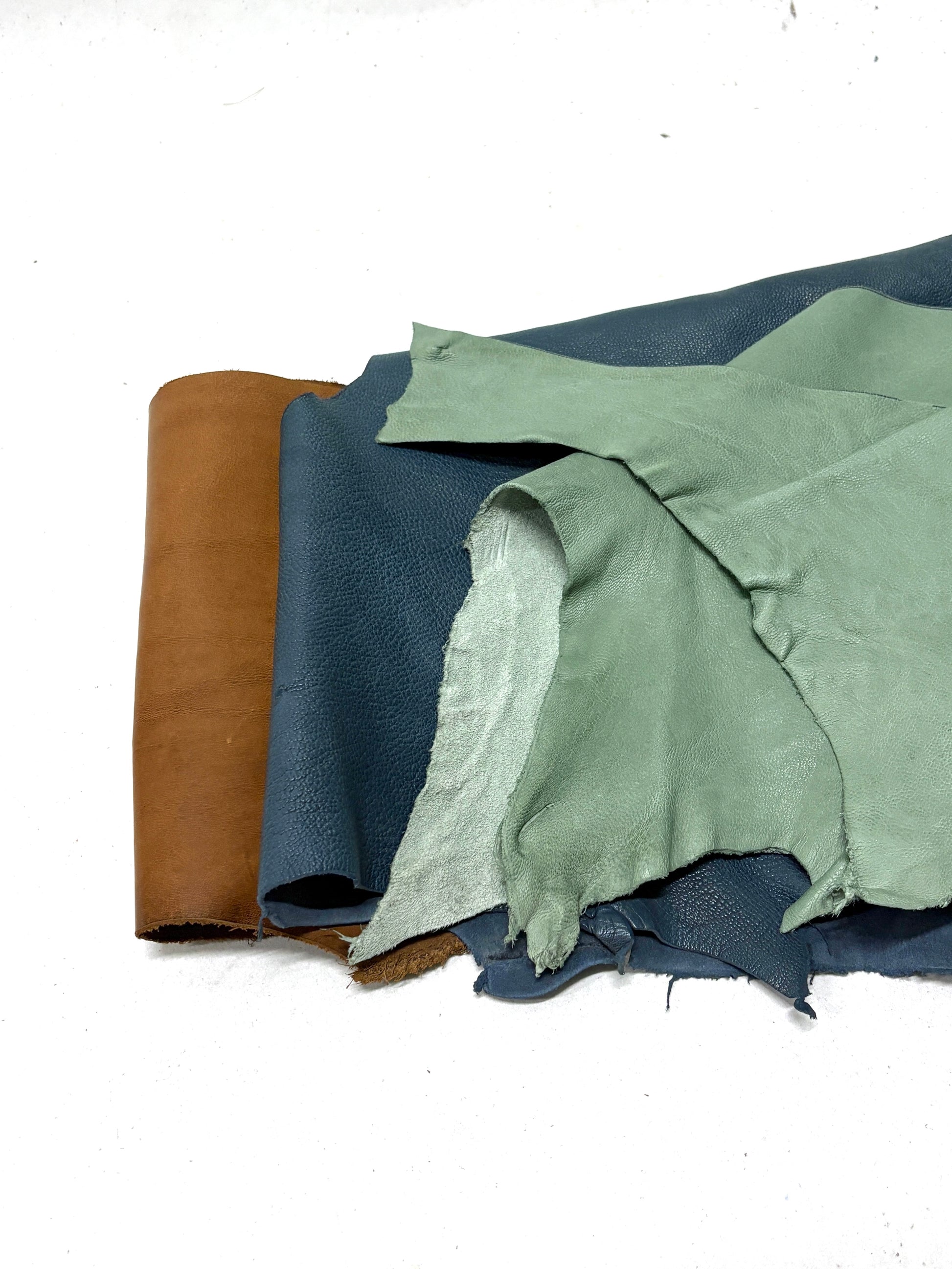 Collection of various coloured leather rolls, some have cut parts
