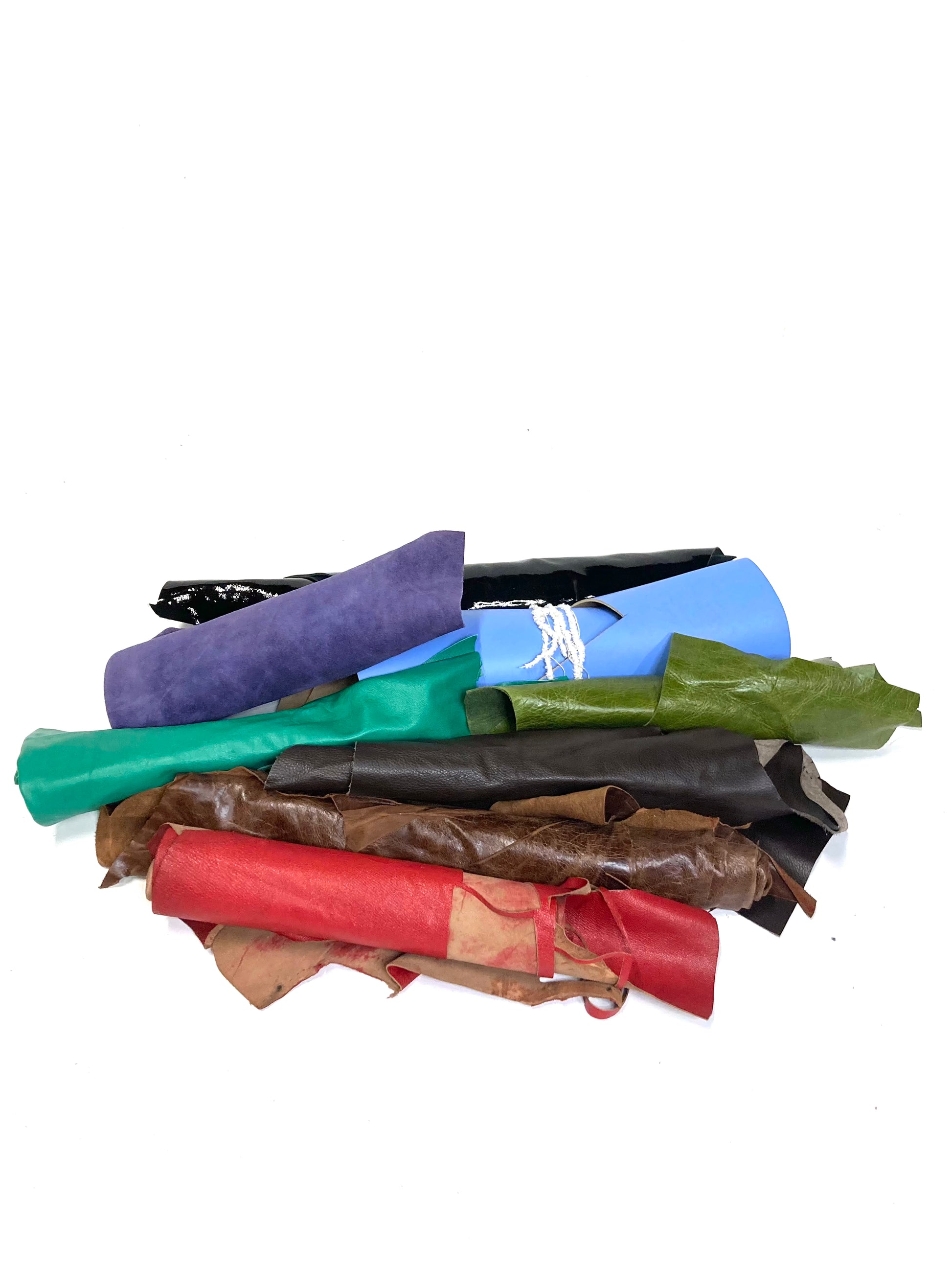 Collection of various coloured leather rolls, some have cut parts