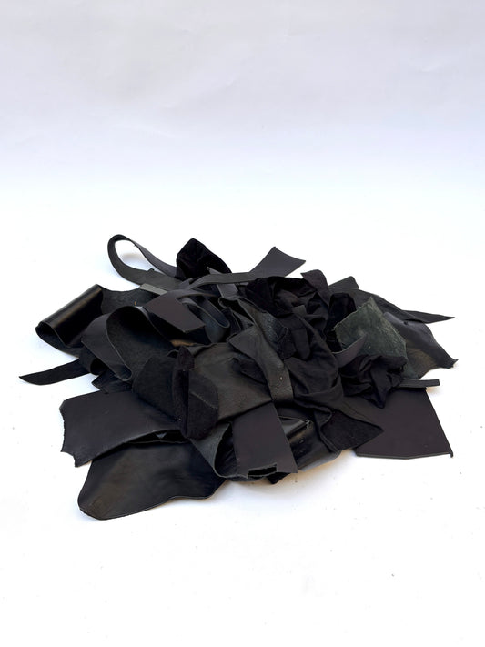 Pile of black leather offcuts with various textures 