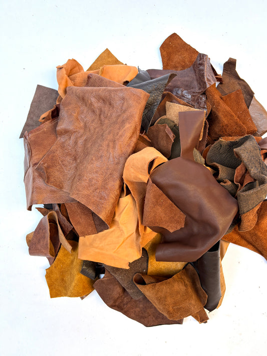 Pile of various types of brown leather offcuts with various sizes