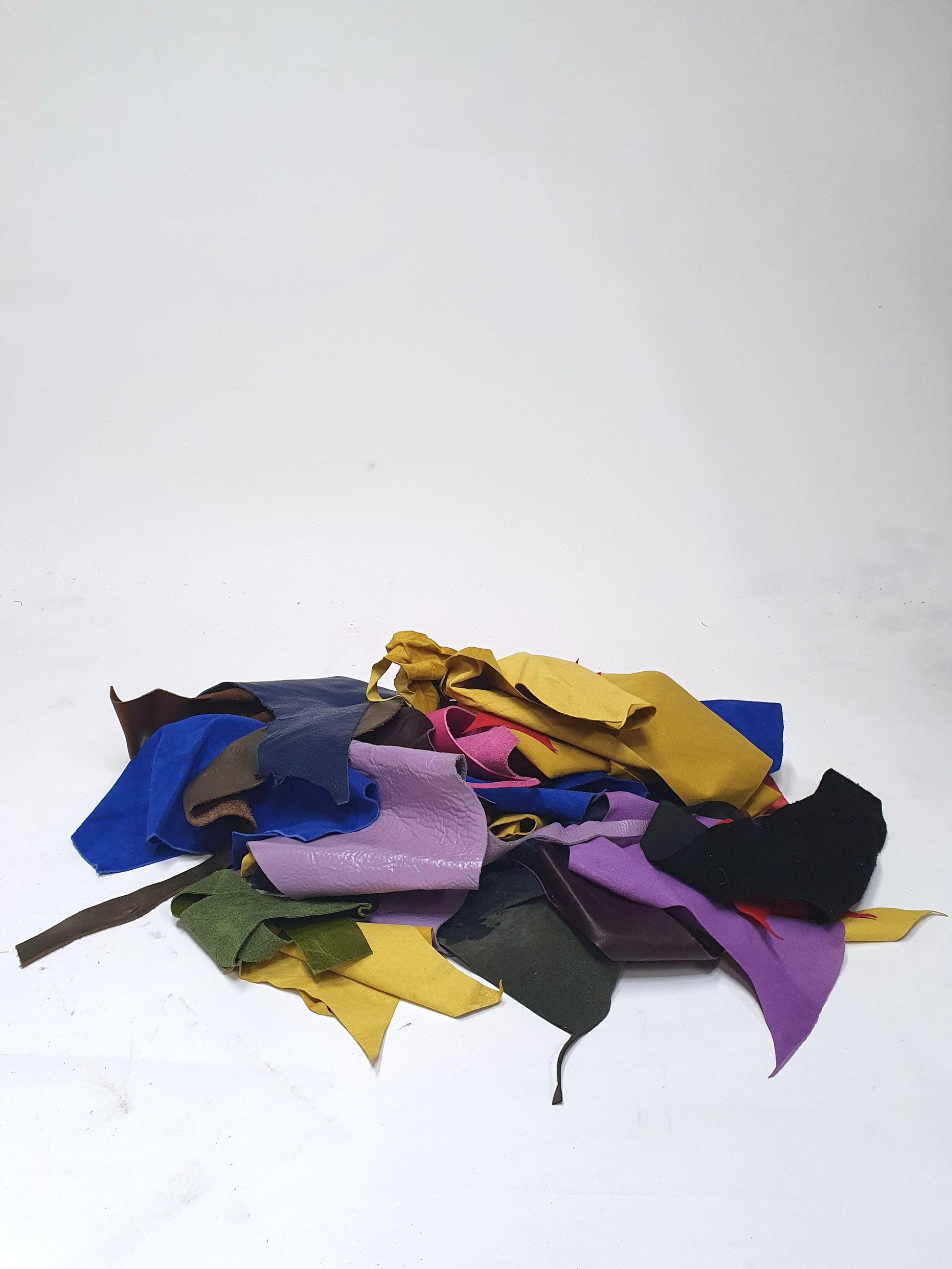 Pile of colourful leather offcuts with various sizes