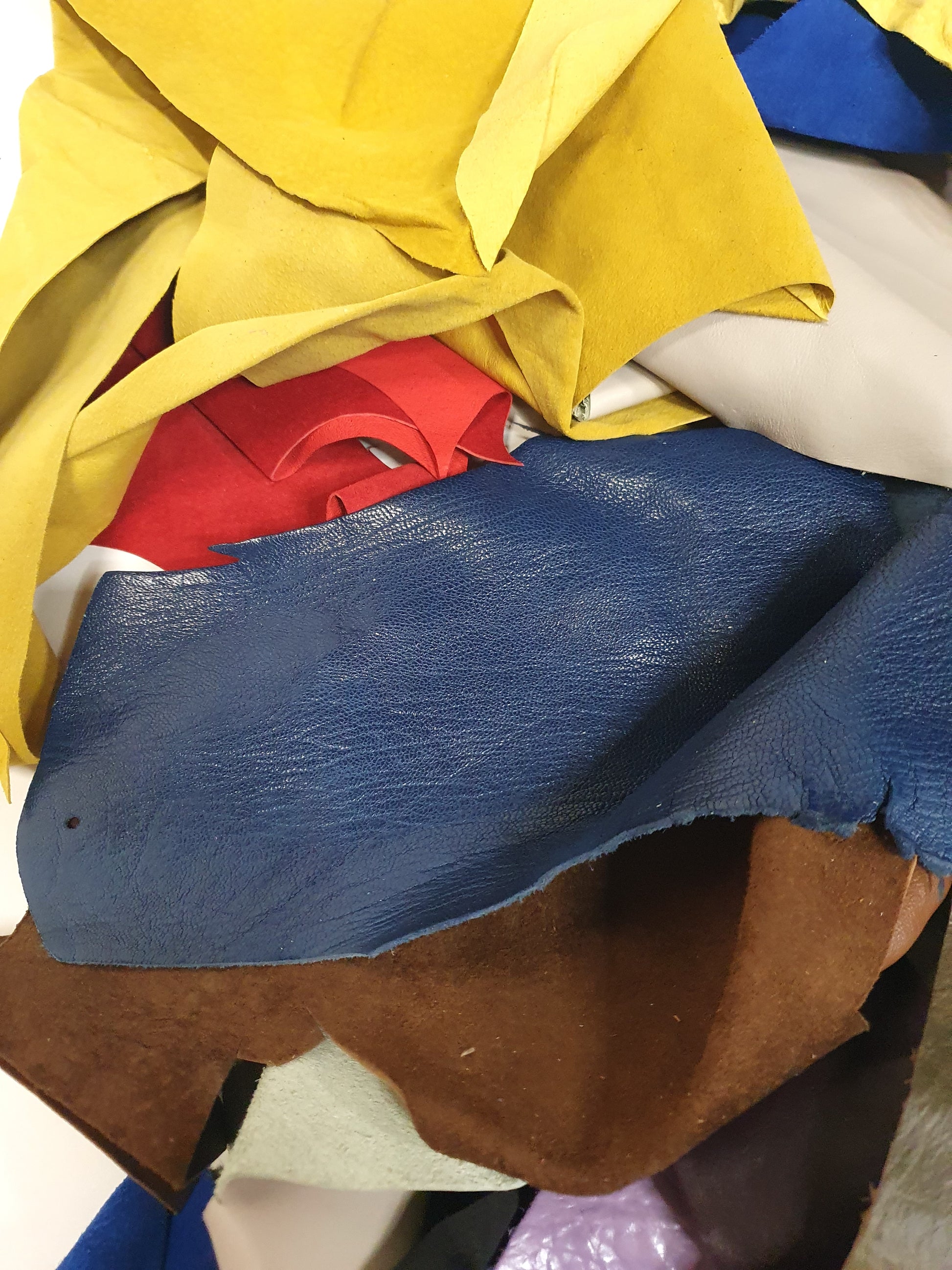 Close-up of colourful leather offcuts with various textures 