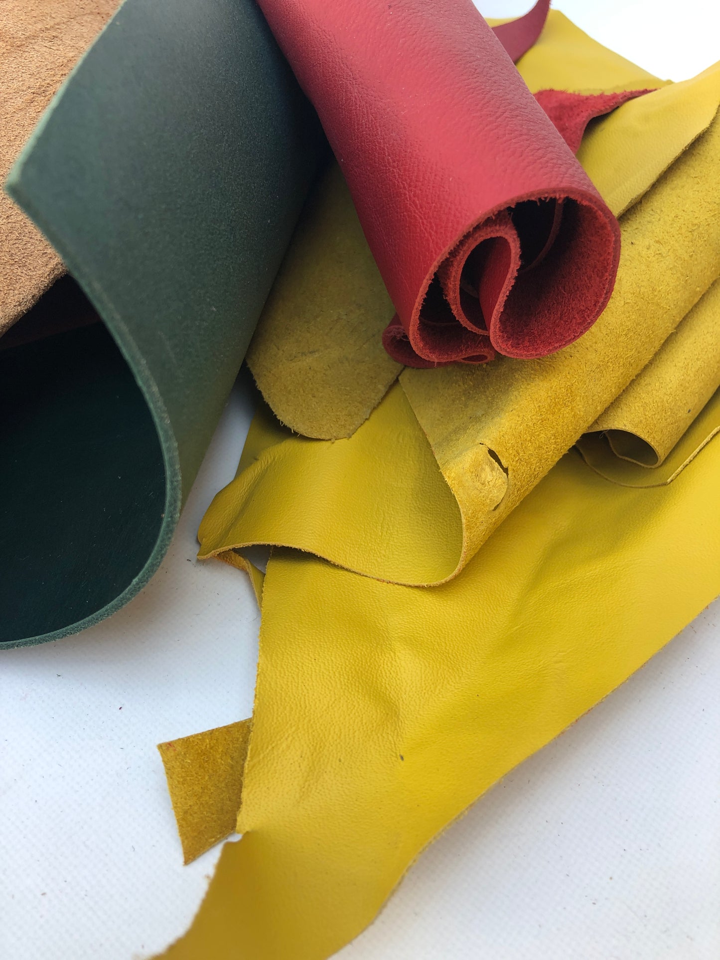 Close-up of offcuts of leather with red, yellow, green