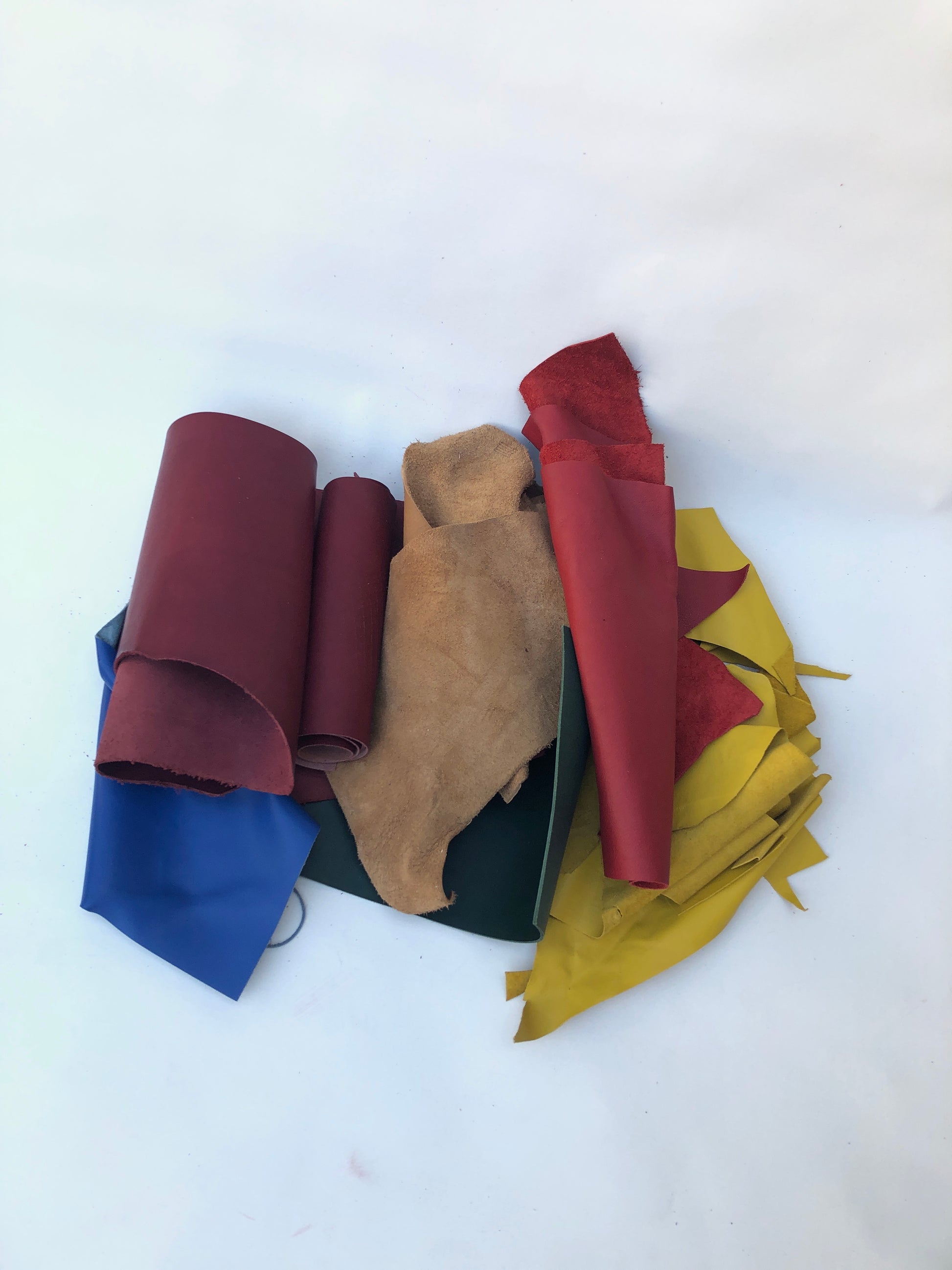 Pile of offcuts of leather with various colours, various sizes 