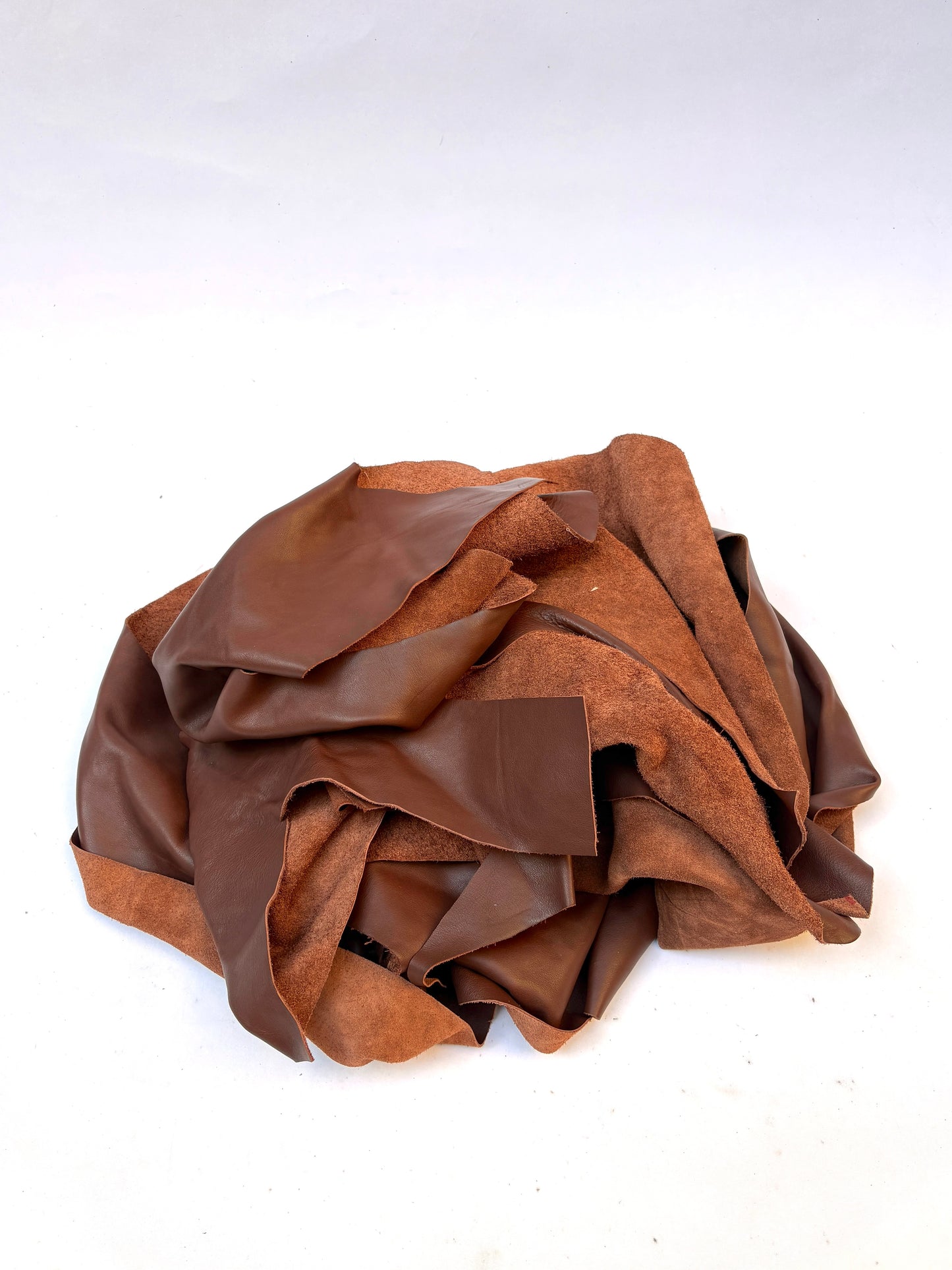 Pile of light brown leather offcuts 