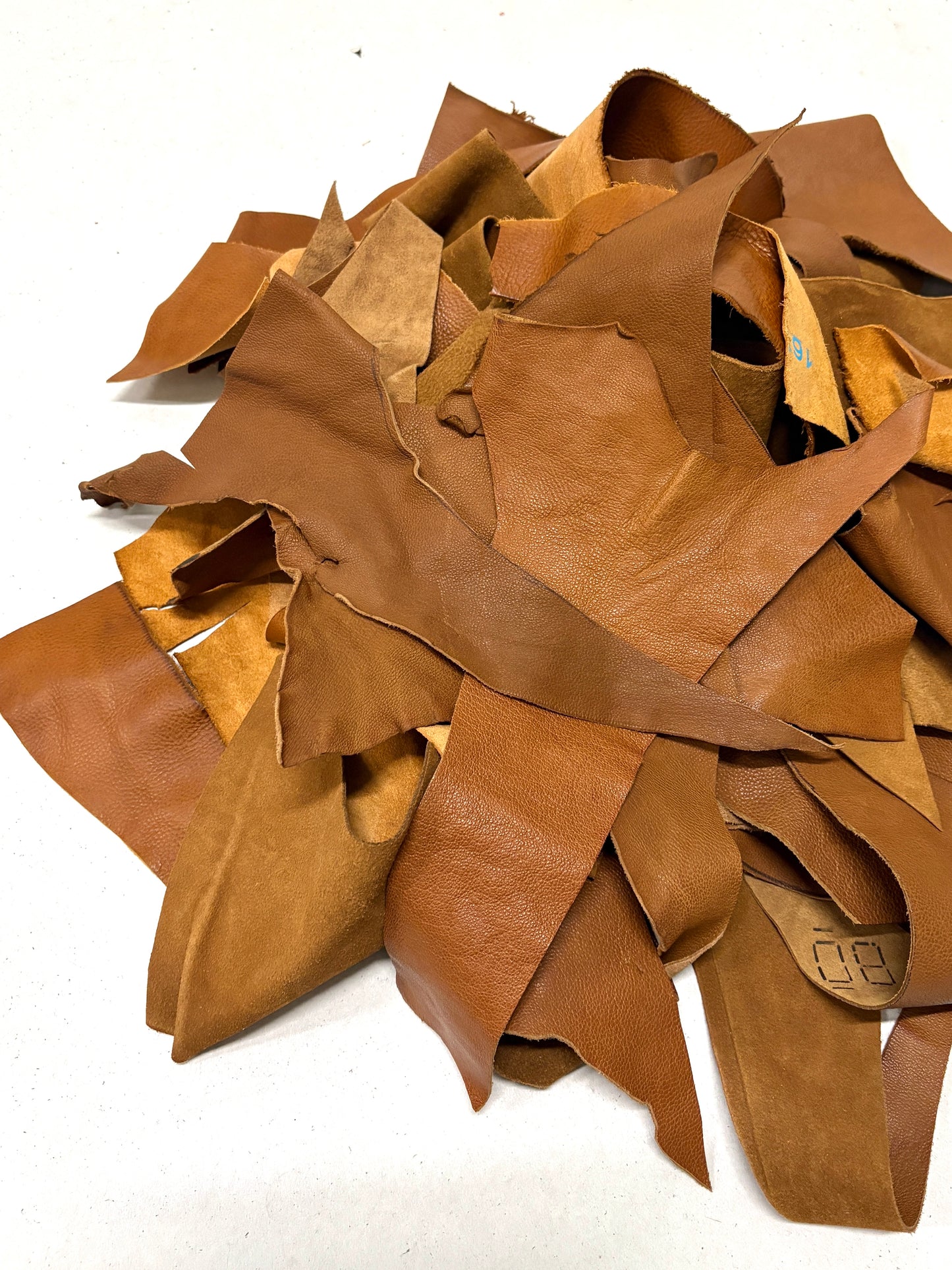 Pile of light brown leather offcuts 