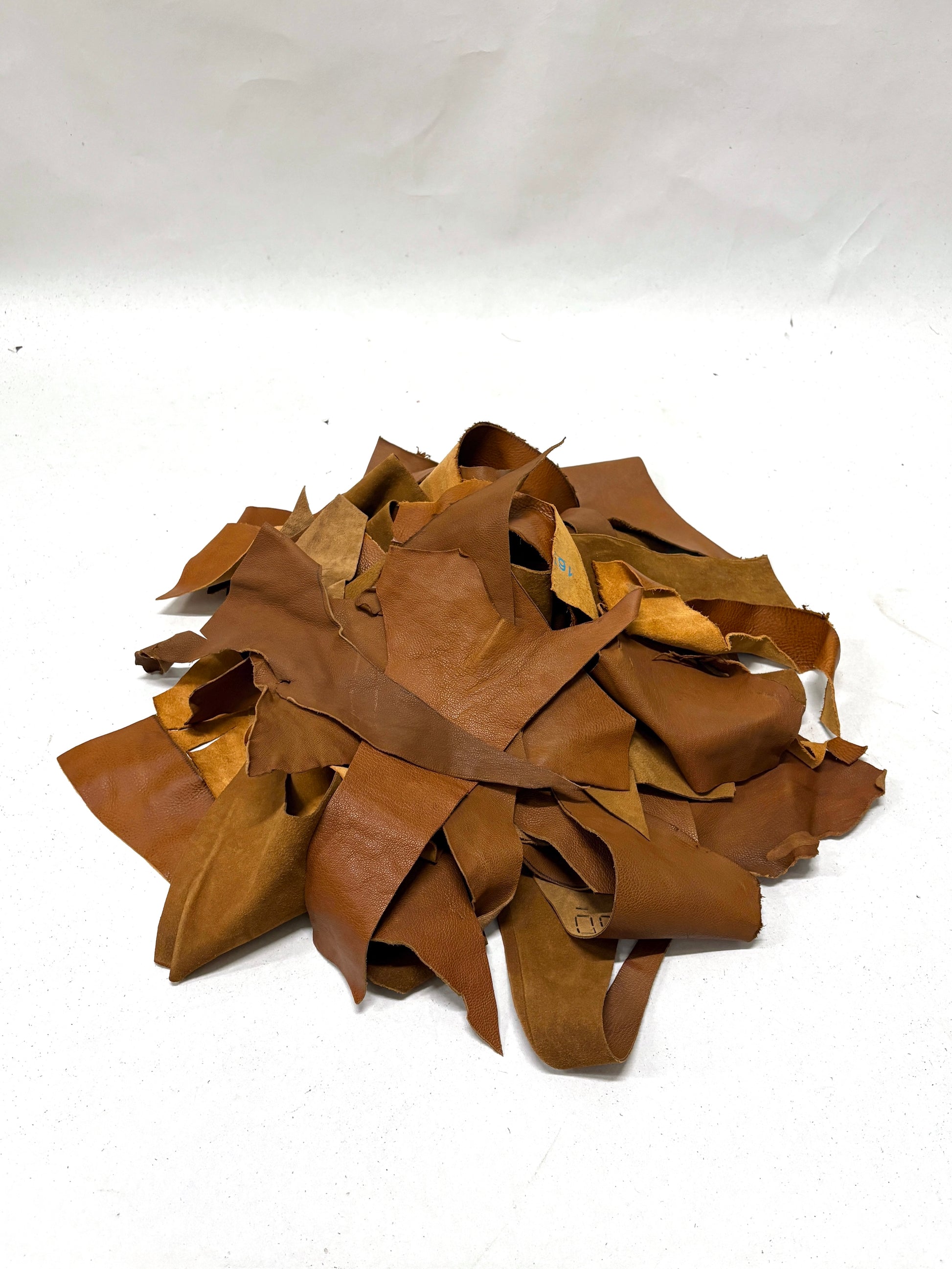 Pile of light brown leather offcuts 