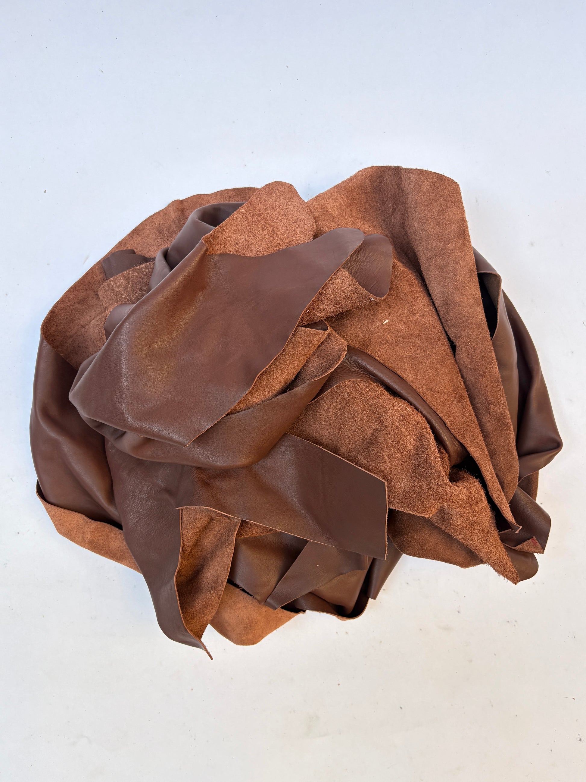 Pile of light brown leather offcuts 