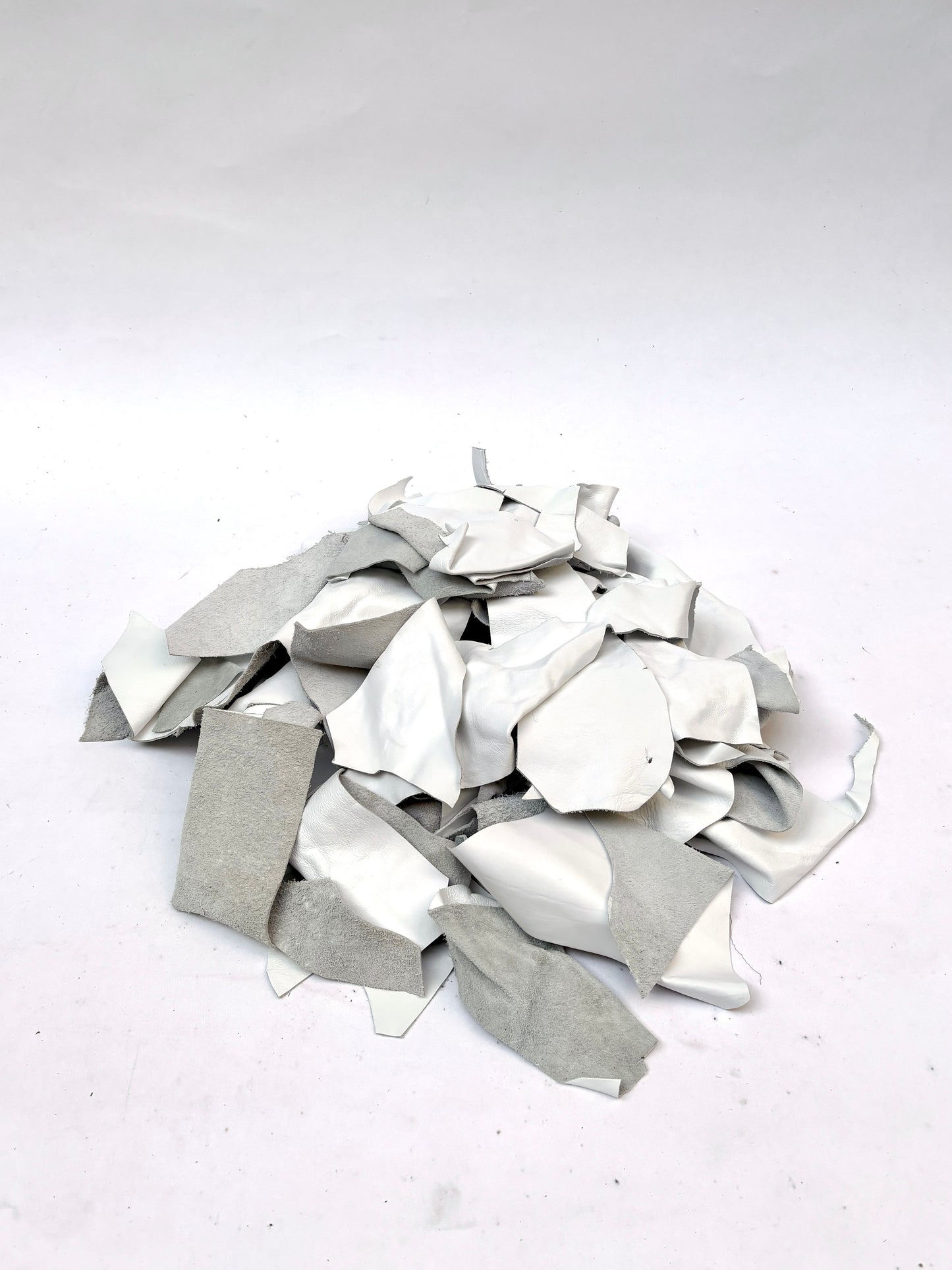 Collection of white off-cut leather pieces 
