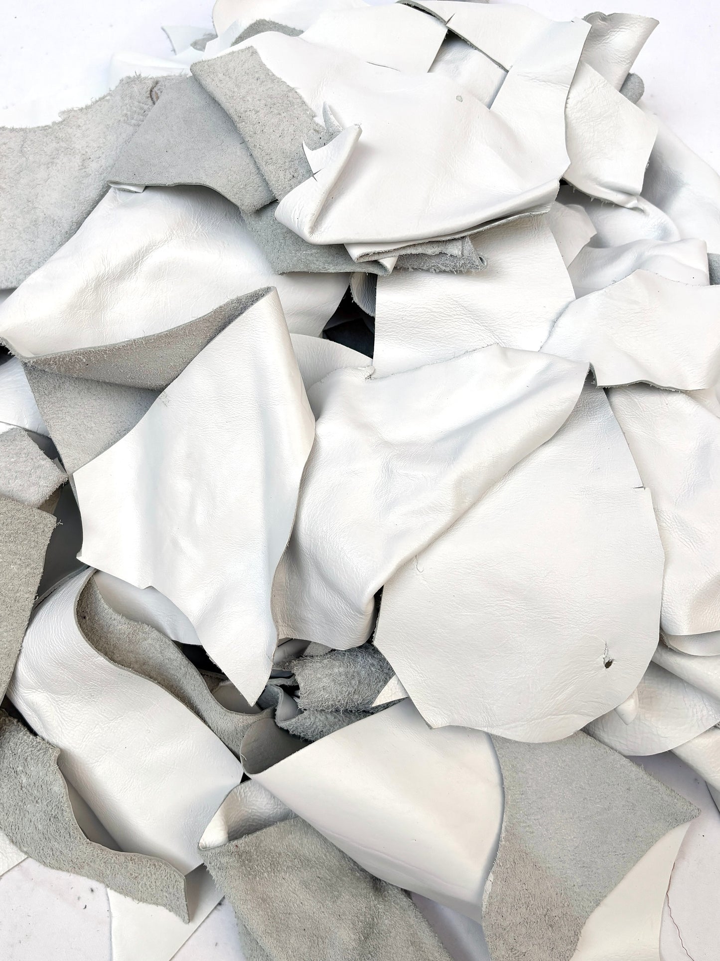 Close-up of white off-cut leather pieces 