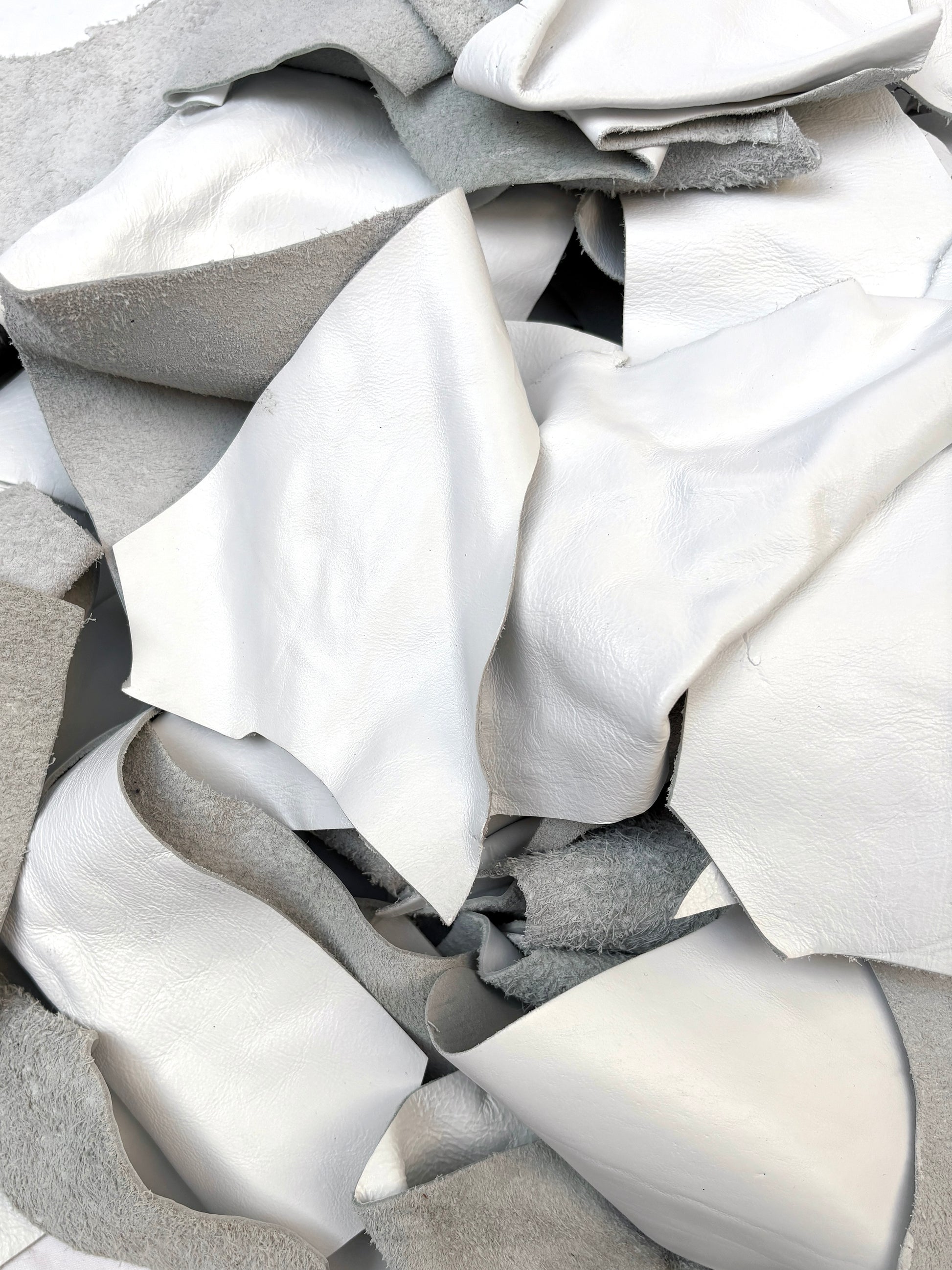 Close-up of white off-cut leather pieces 