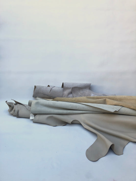 Collection of cream coloured leather pieces with soft texture 