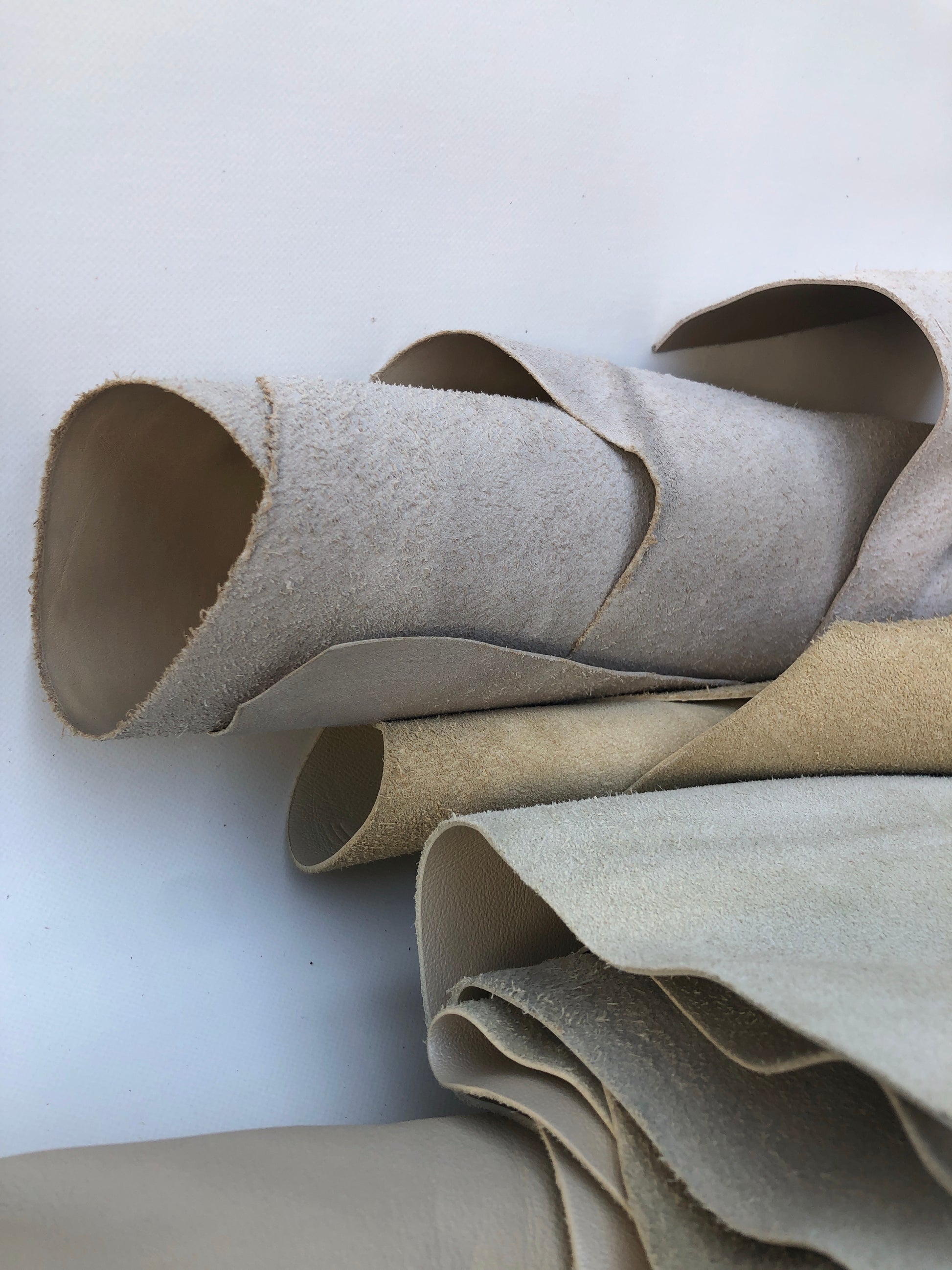 Collection of cream coloured leather pieces with soft texture 