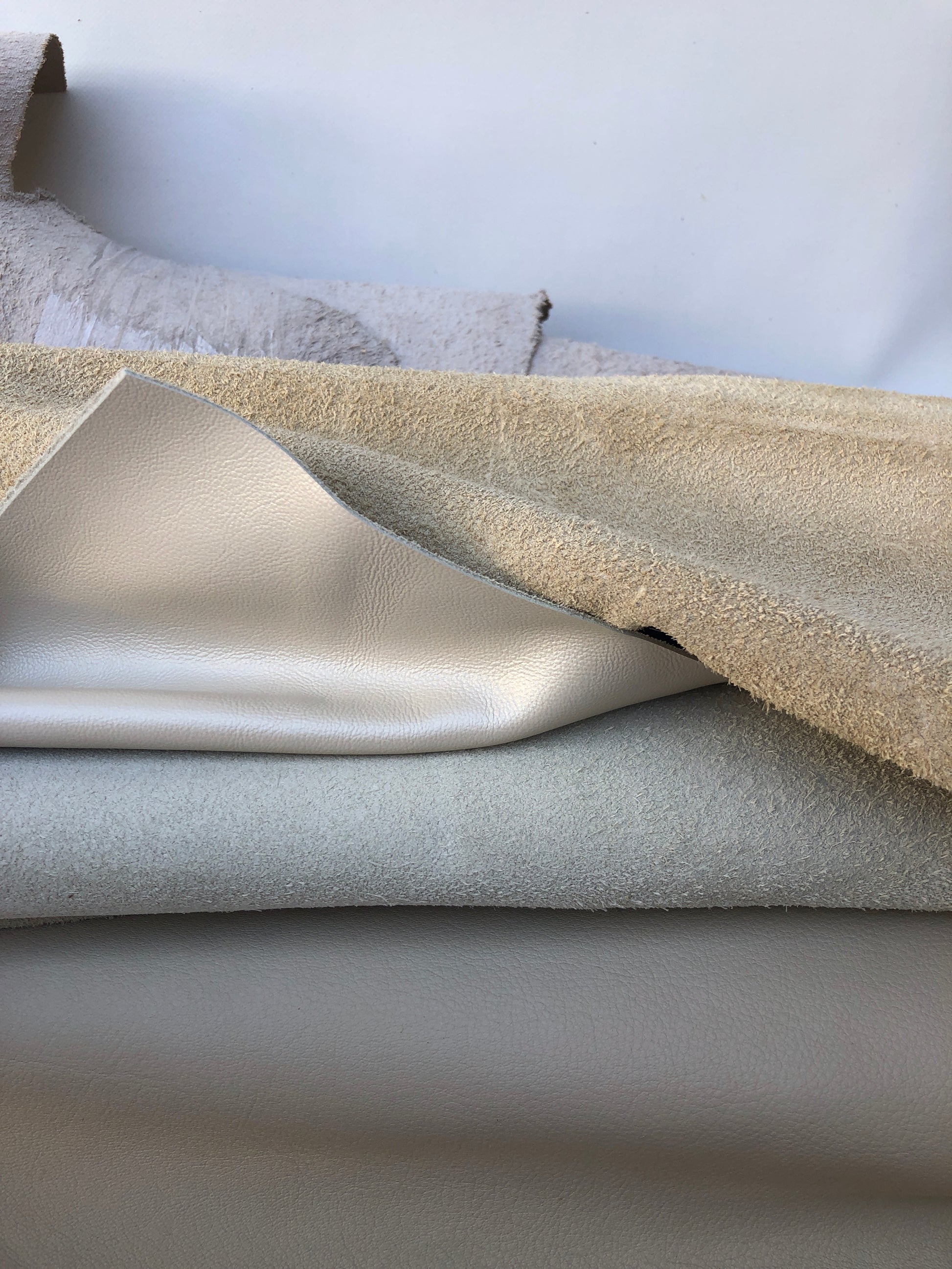 Close-up of cream coloured leather pieces with soft texture 
