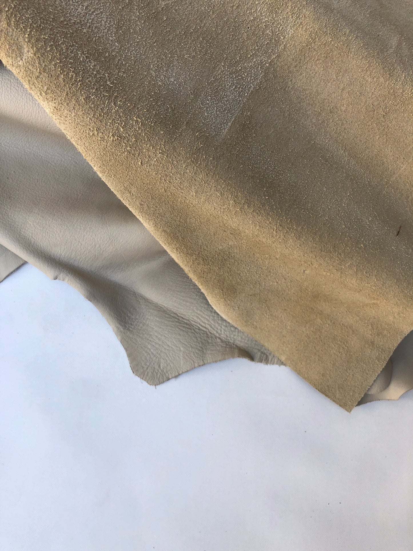 Close-up of cream coloured leather pieces with soft texture 