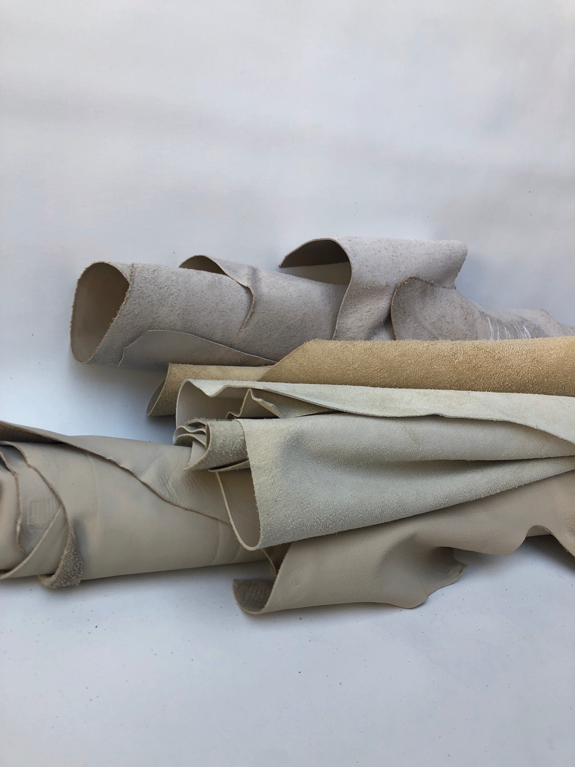 Collection of cream coloured leather pieces with soft texture 