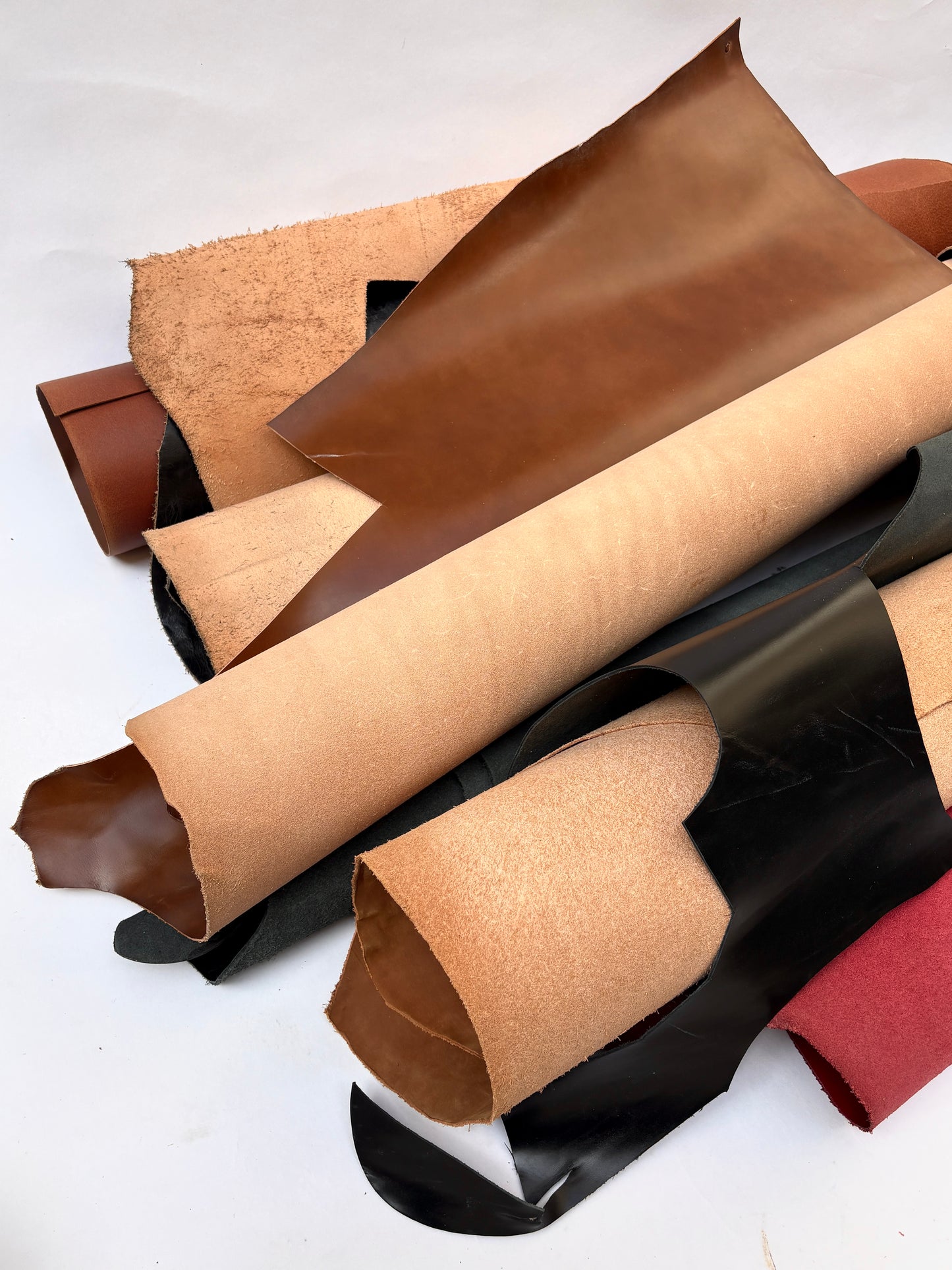 Collection of leather pieces in brown, black, red