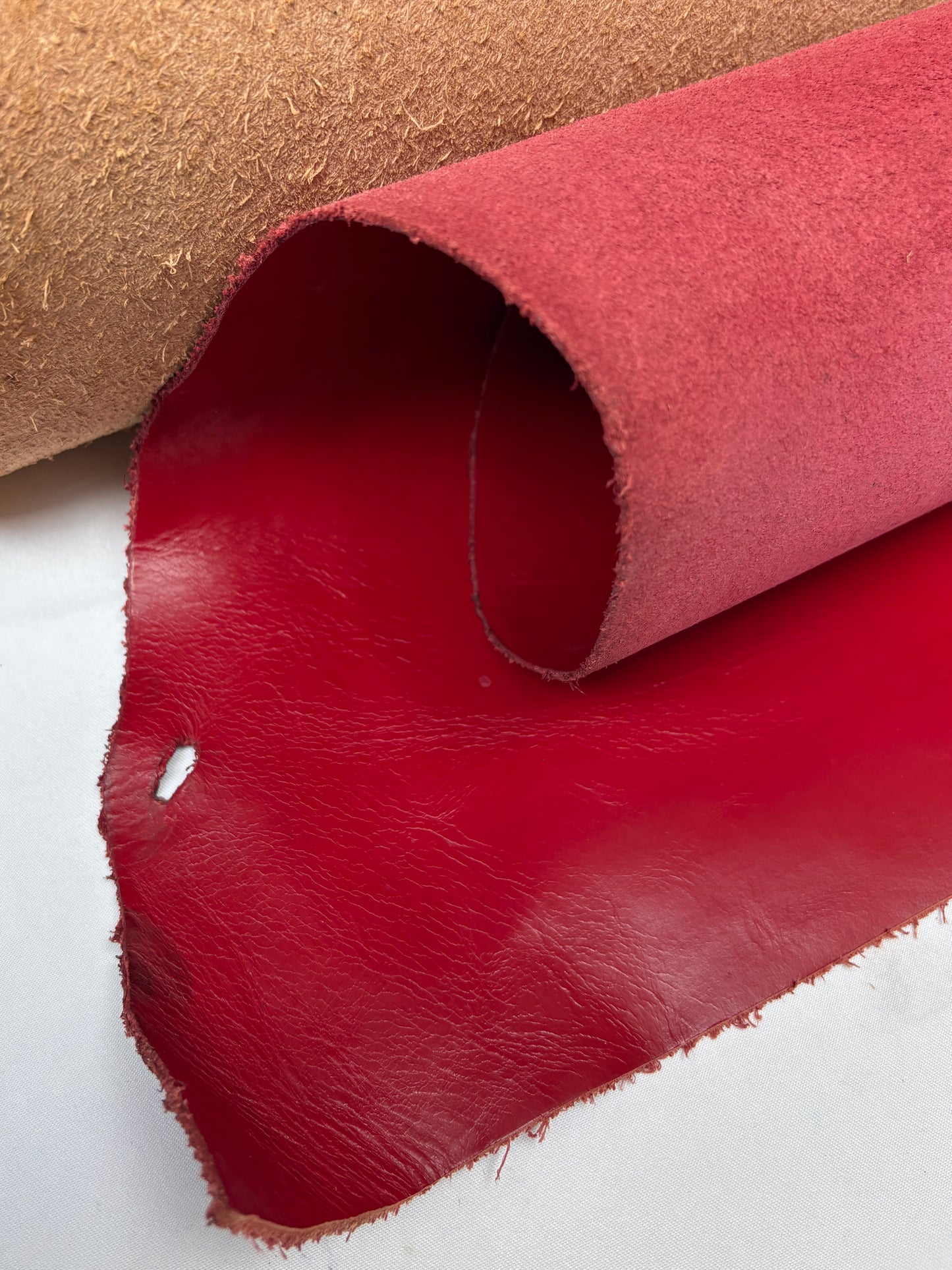 Roll of red leather with a small hole