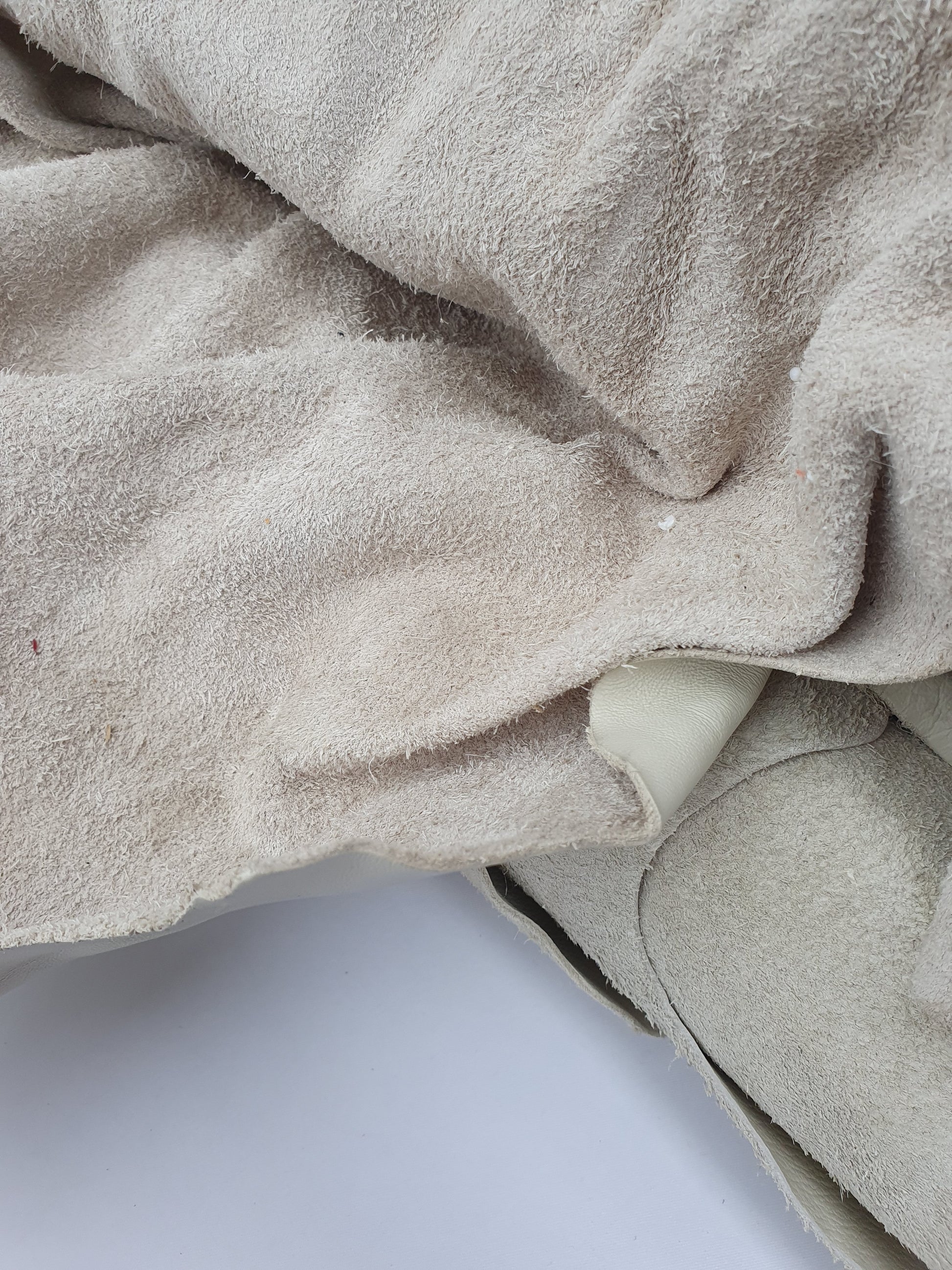 Unfolded cowhide bone white leather with visible texture 