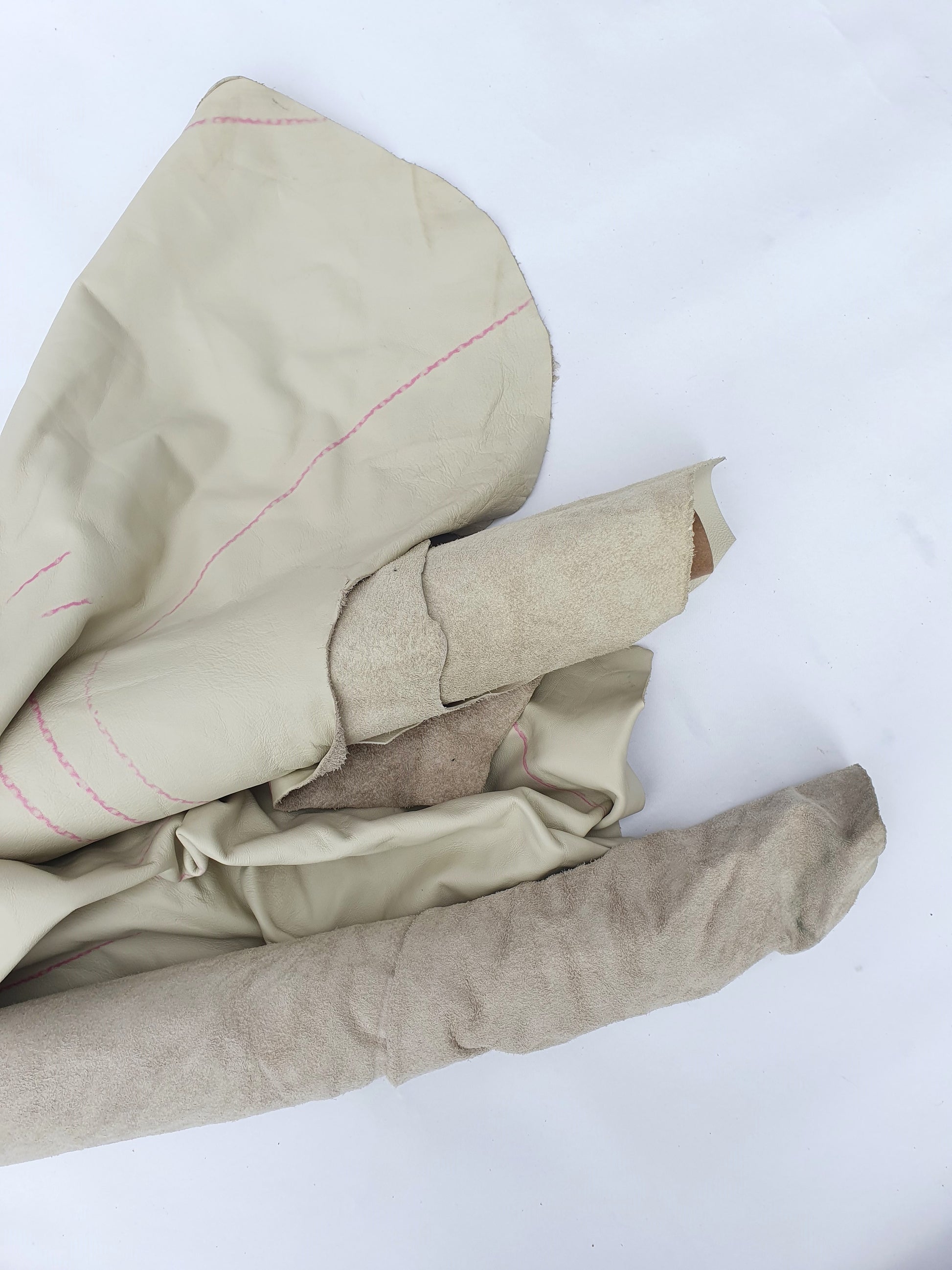 Two cowhide bone white rolled leather with visible marking lines