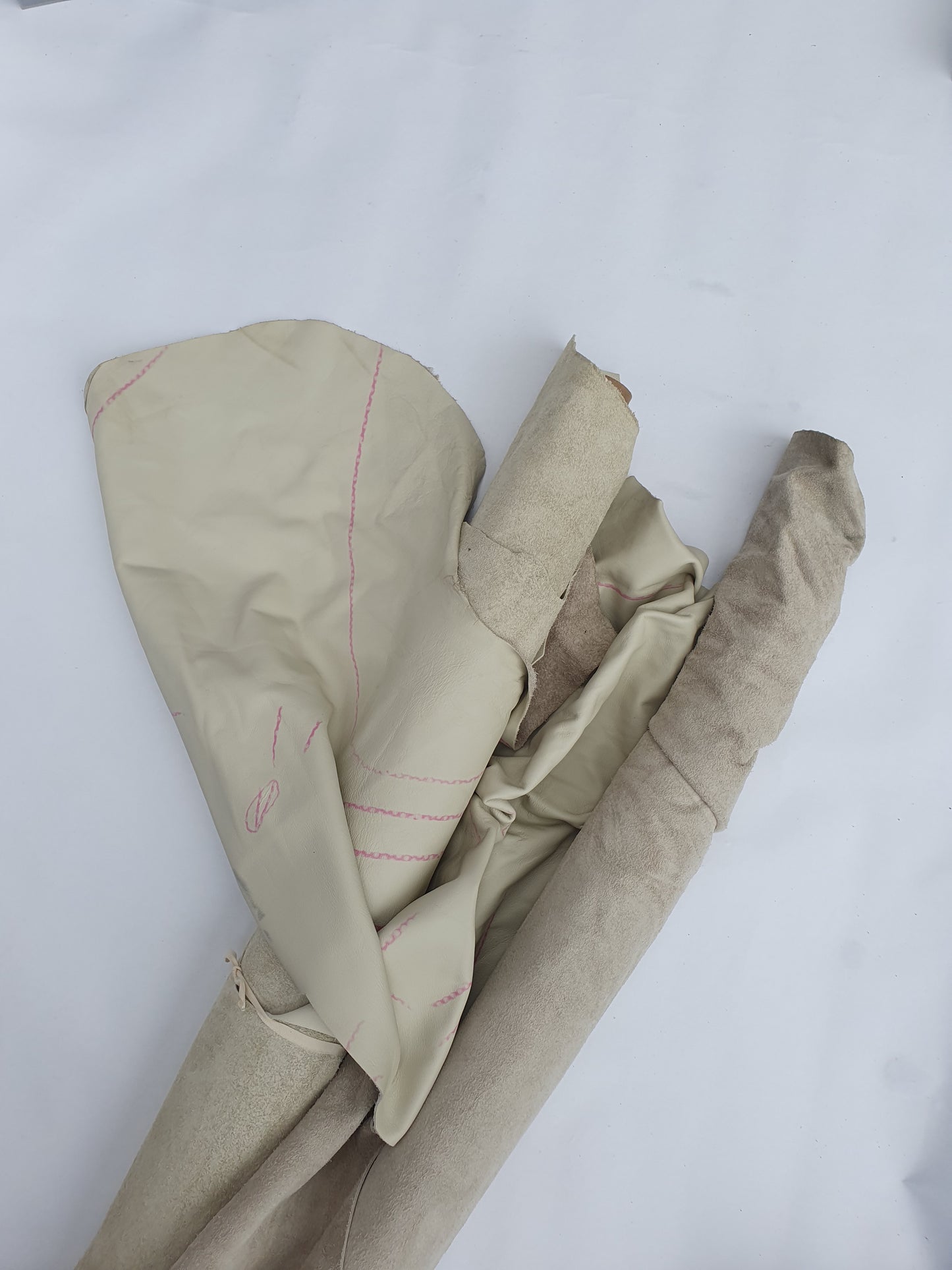 Two cowhide bone white rolled leather with visible marking lines