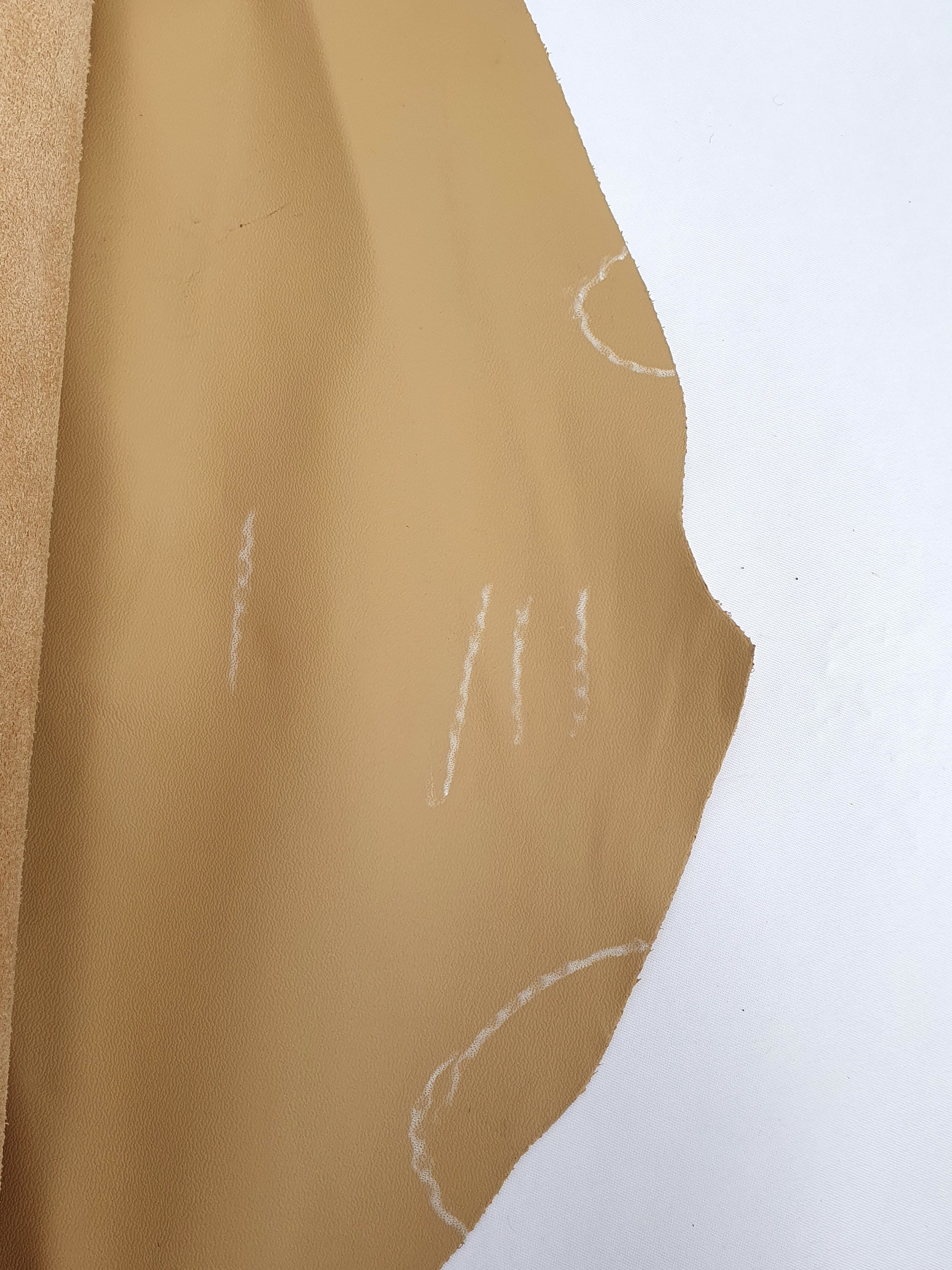 Unfolded cowhide camel rolled leather with visible marking lines 