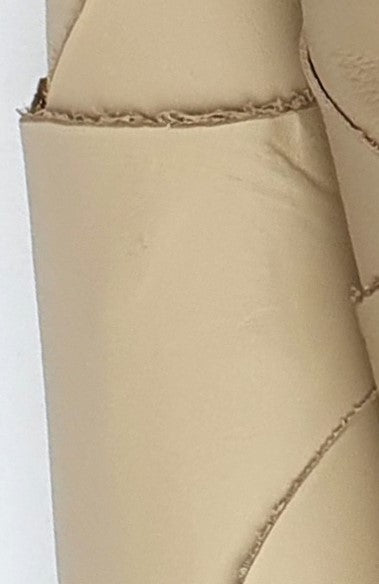 Close-up of two cowhide camel rolled leather with visible textures 