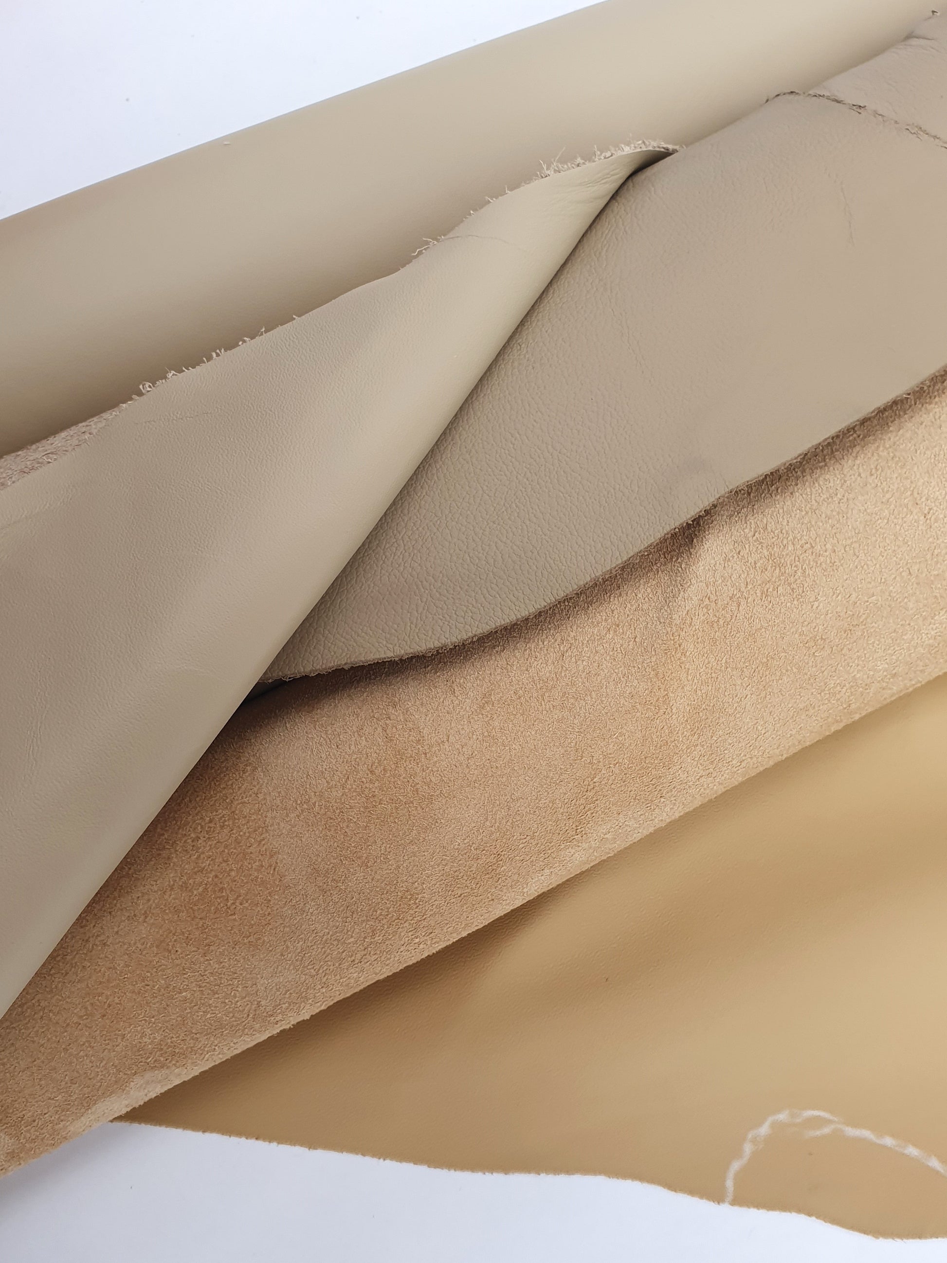 Two cowhide camel rolled leather with visible marking lines 