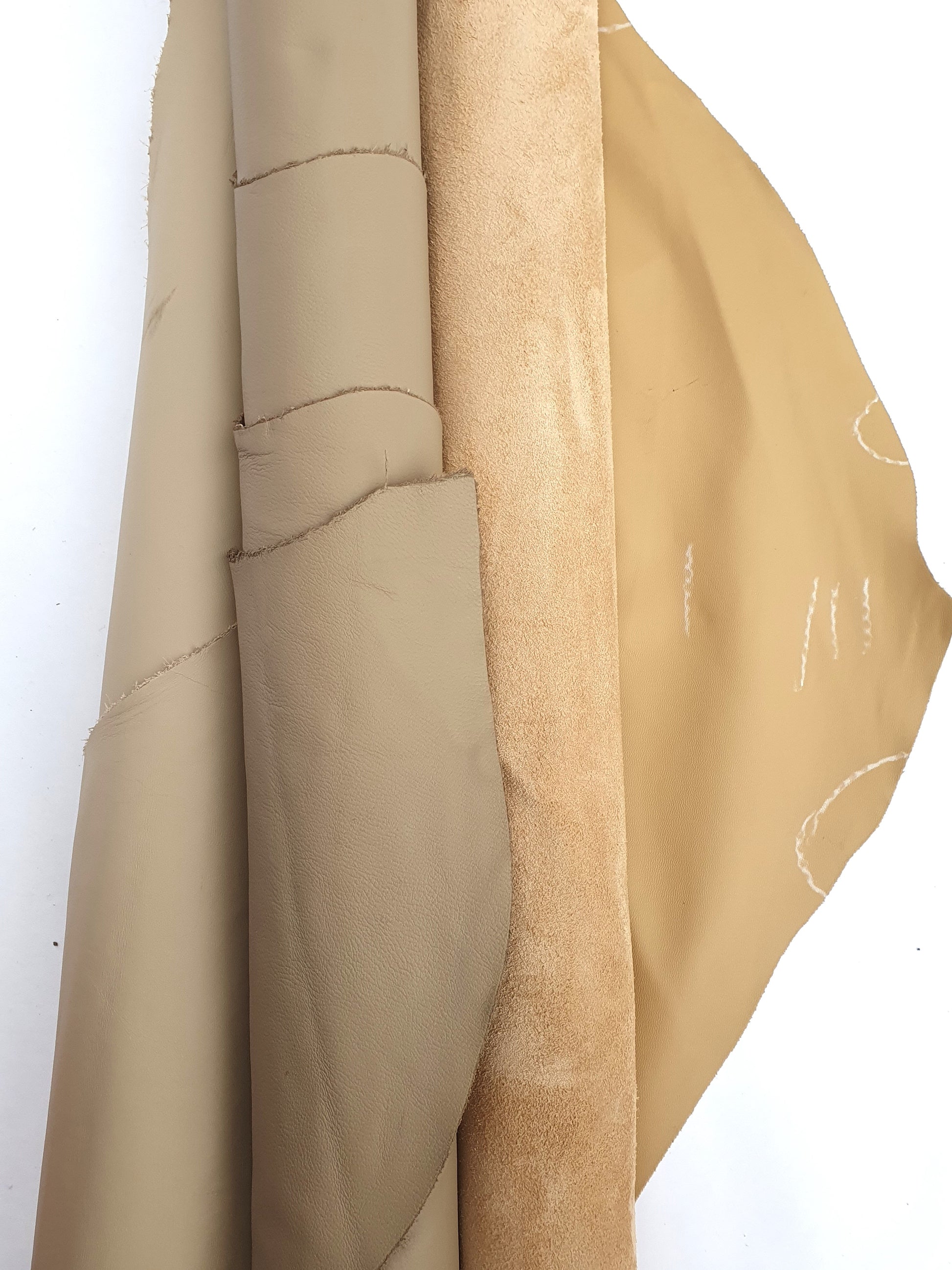 Two cowhide camel rolled leather with visible marking lines 