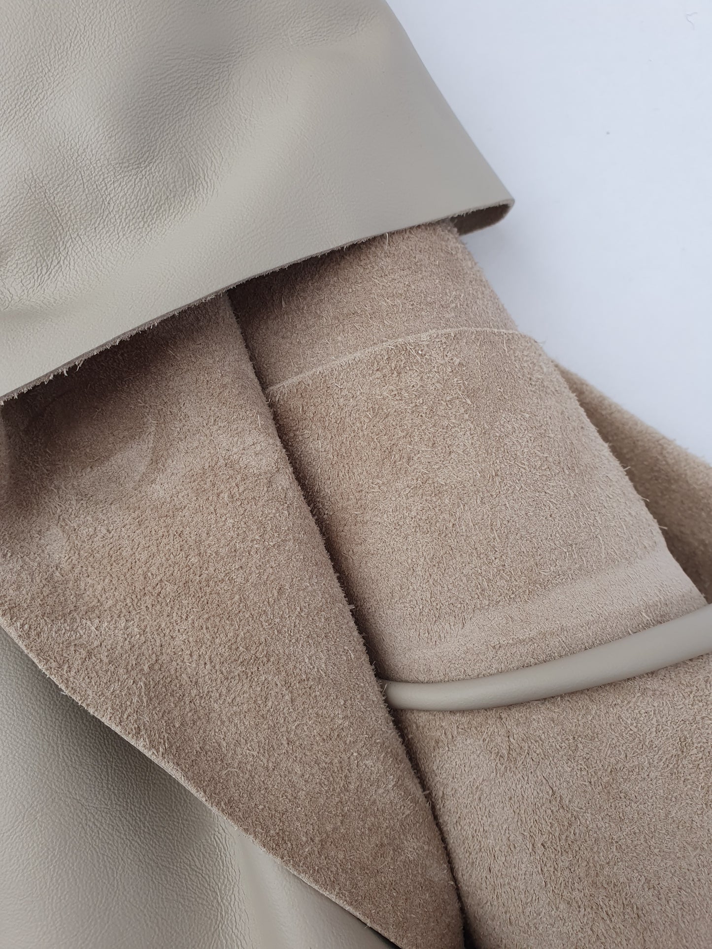 Close-up of beige coloured rolled leather 