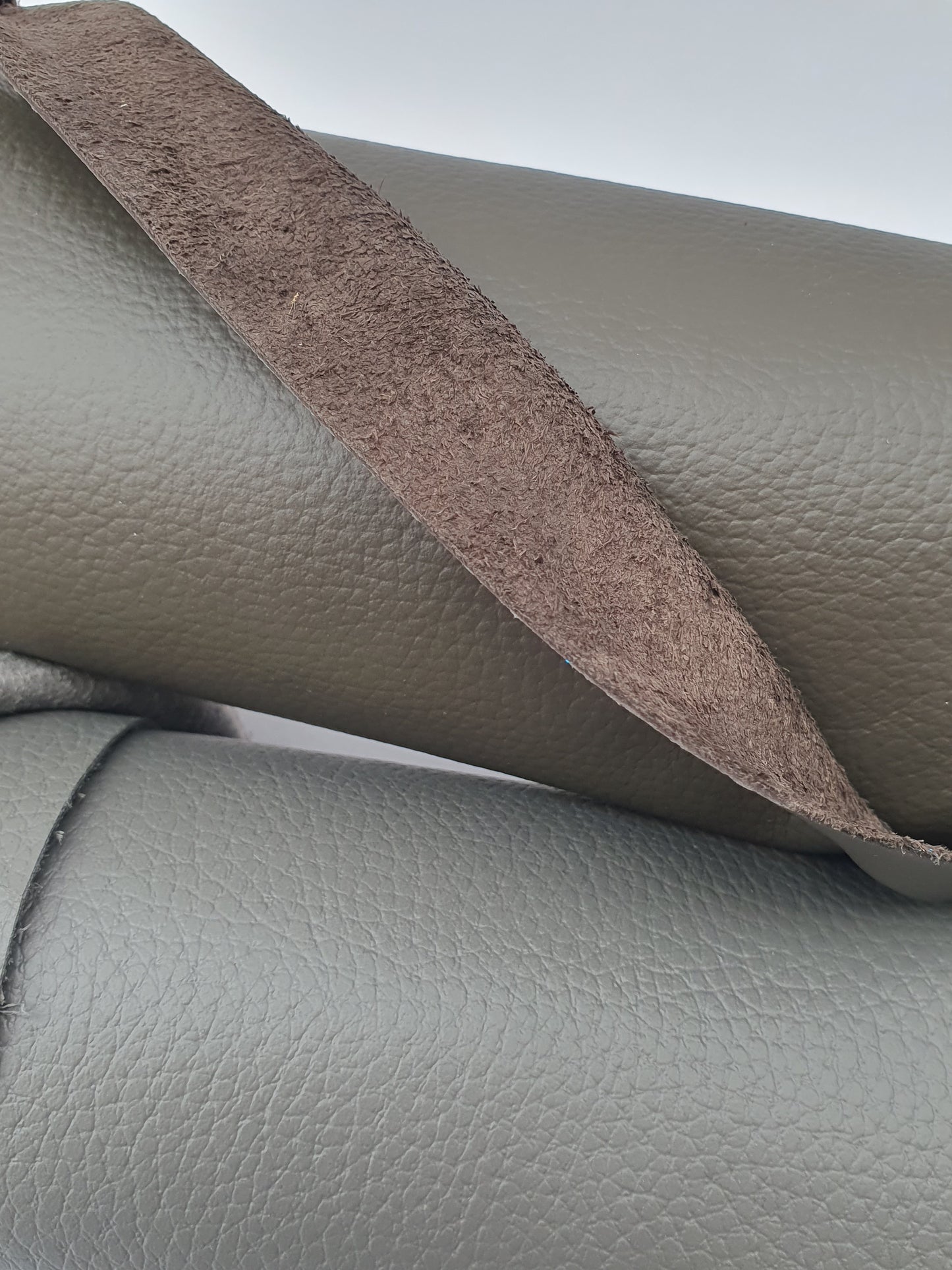 Close-up of grey leather with different textures between front and back 