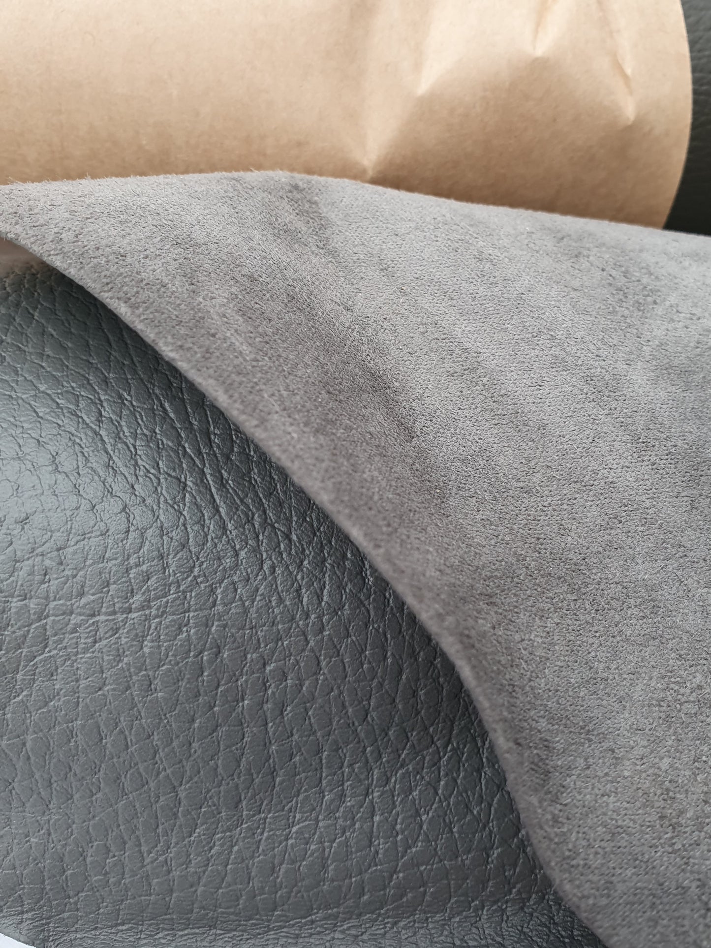 Close-up of grey leather with different textures between front and back 