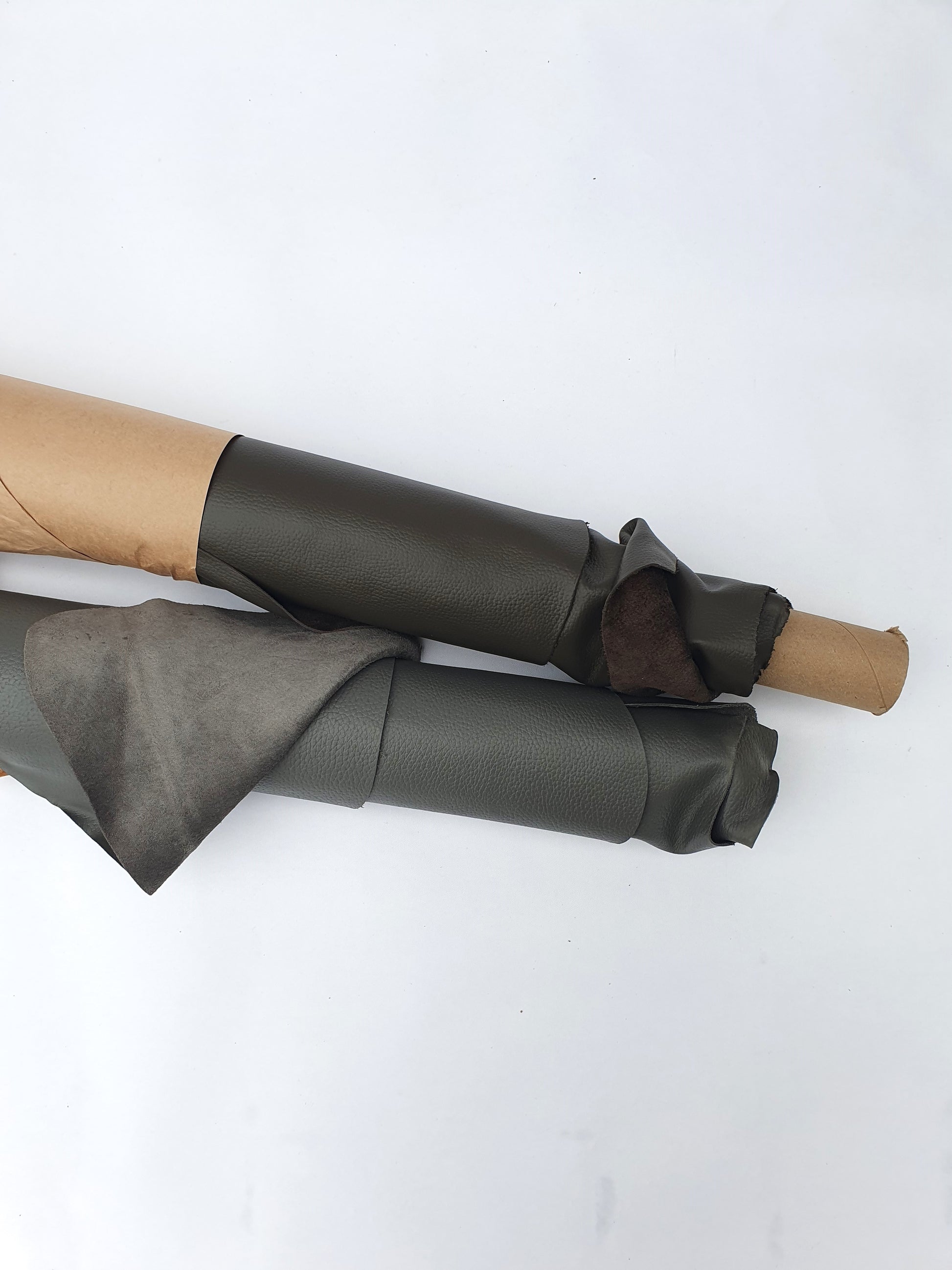 Rolled dark grey to brown leather showing a soft texture and folded edge