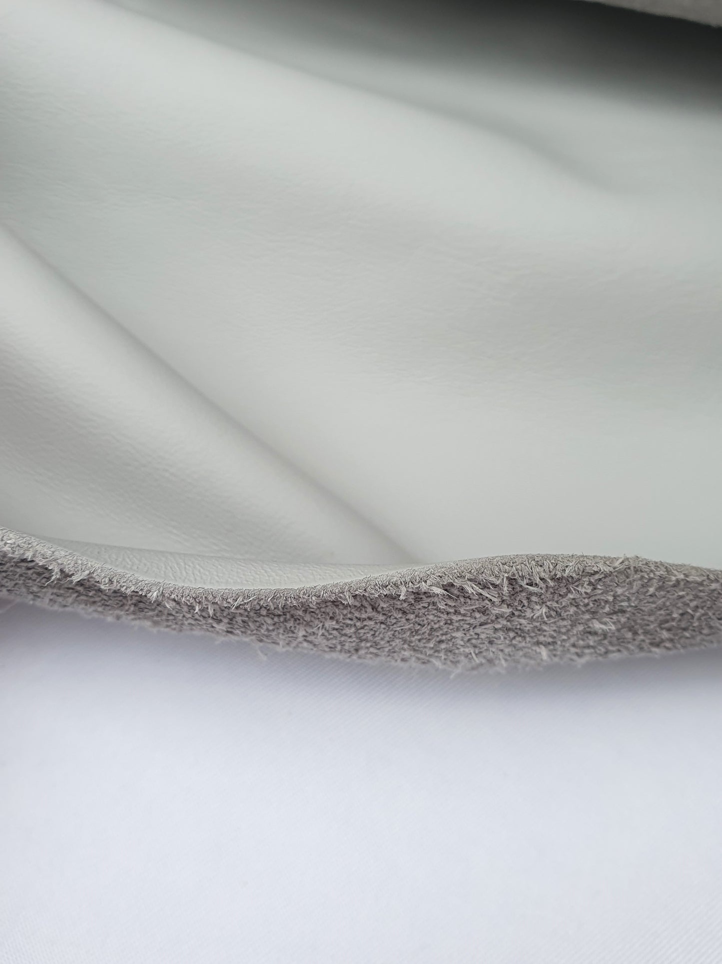 Unfolded leather in light grey, texture visible