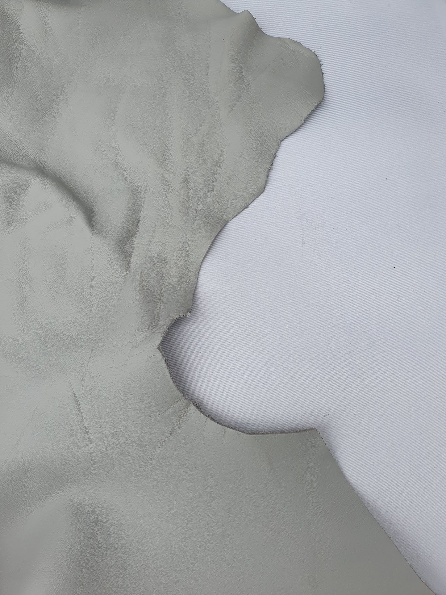 Two rolled leather in grey and light grey, some parts are holed