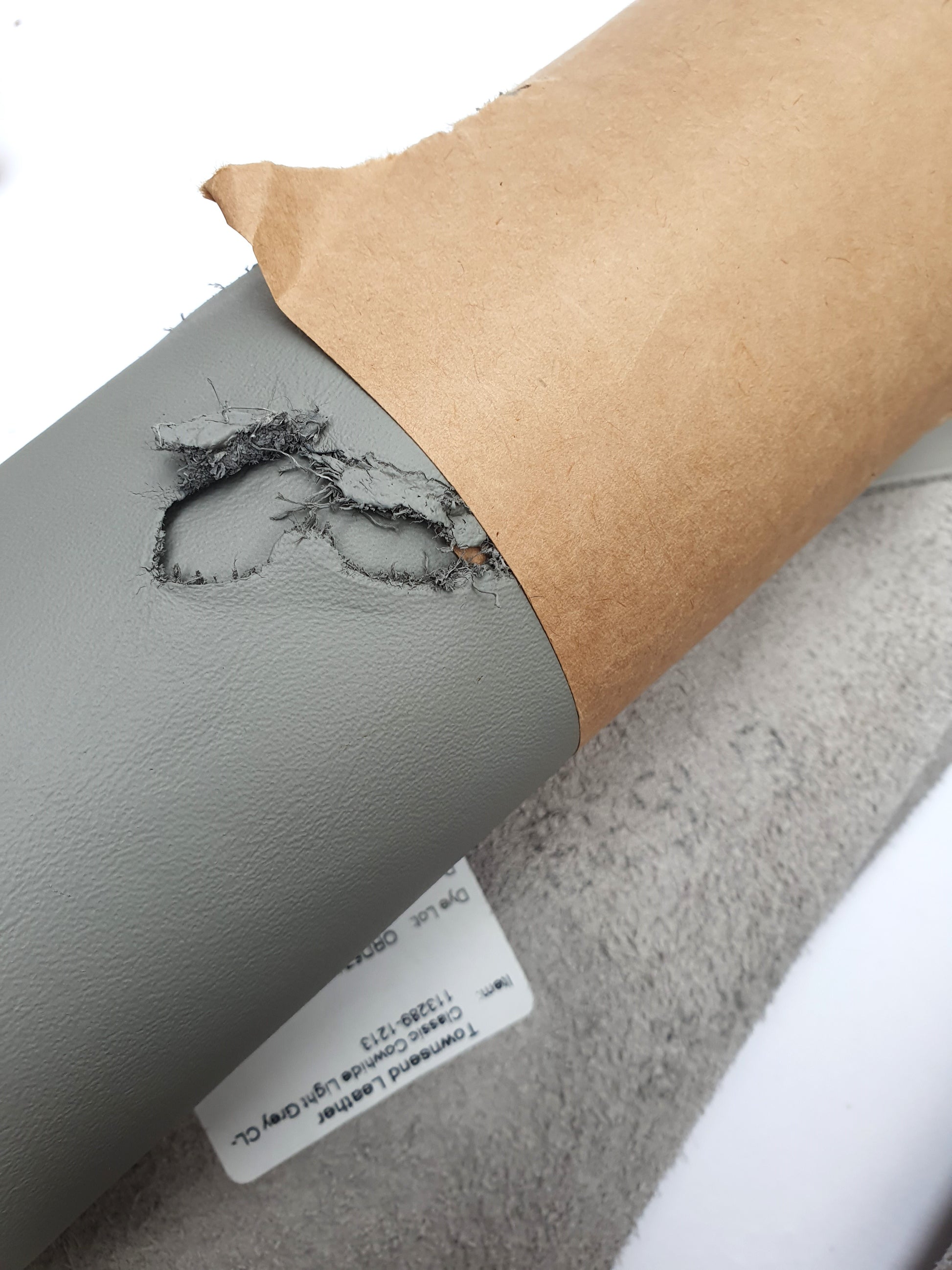 Two rolled leather in grey and light grey, some parts are holed
