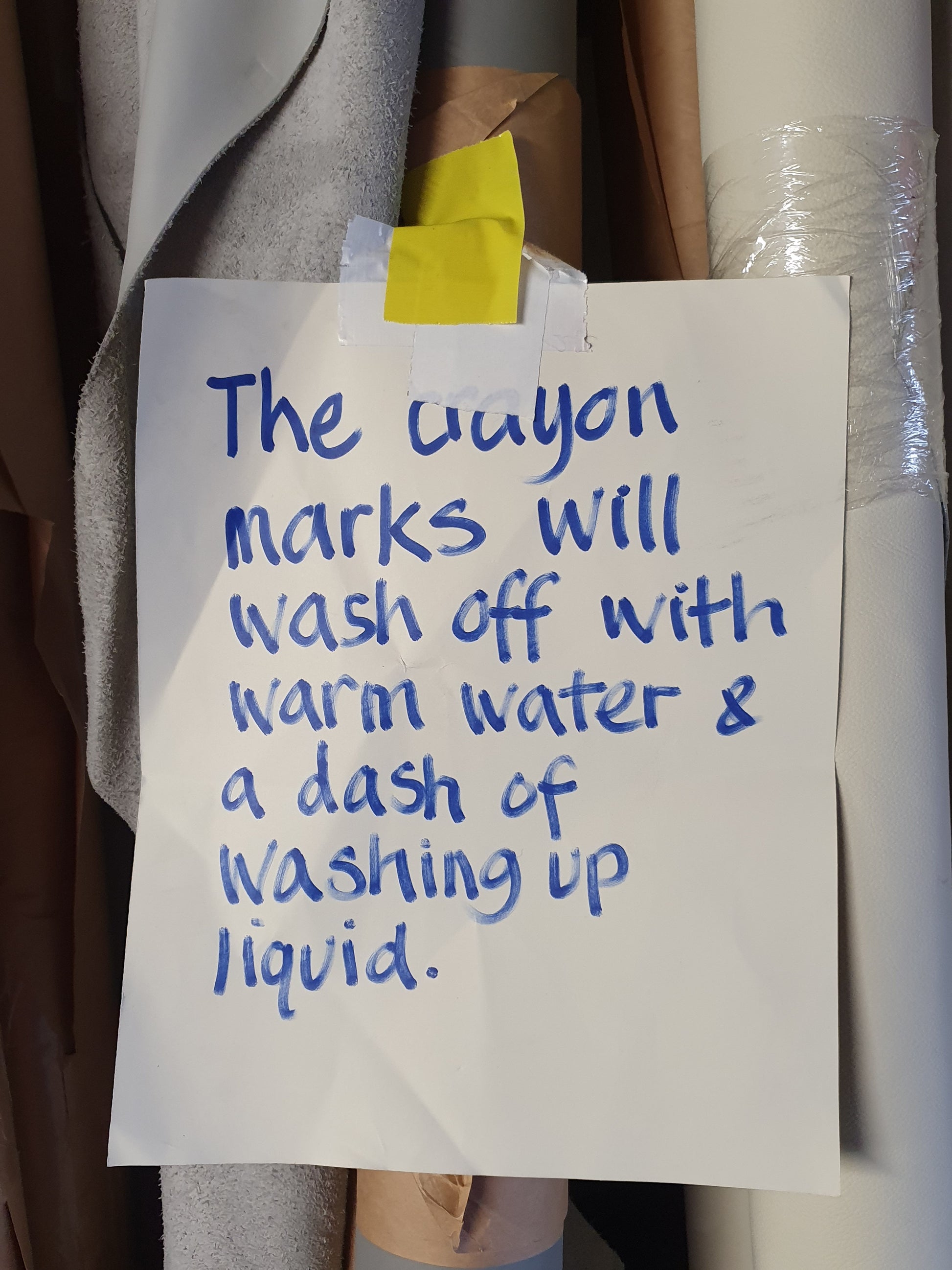 A paper saying the crayon marks will wash off with warm water & a dash of washing up liquid 