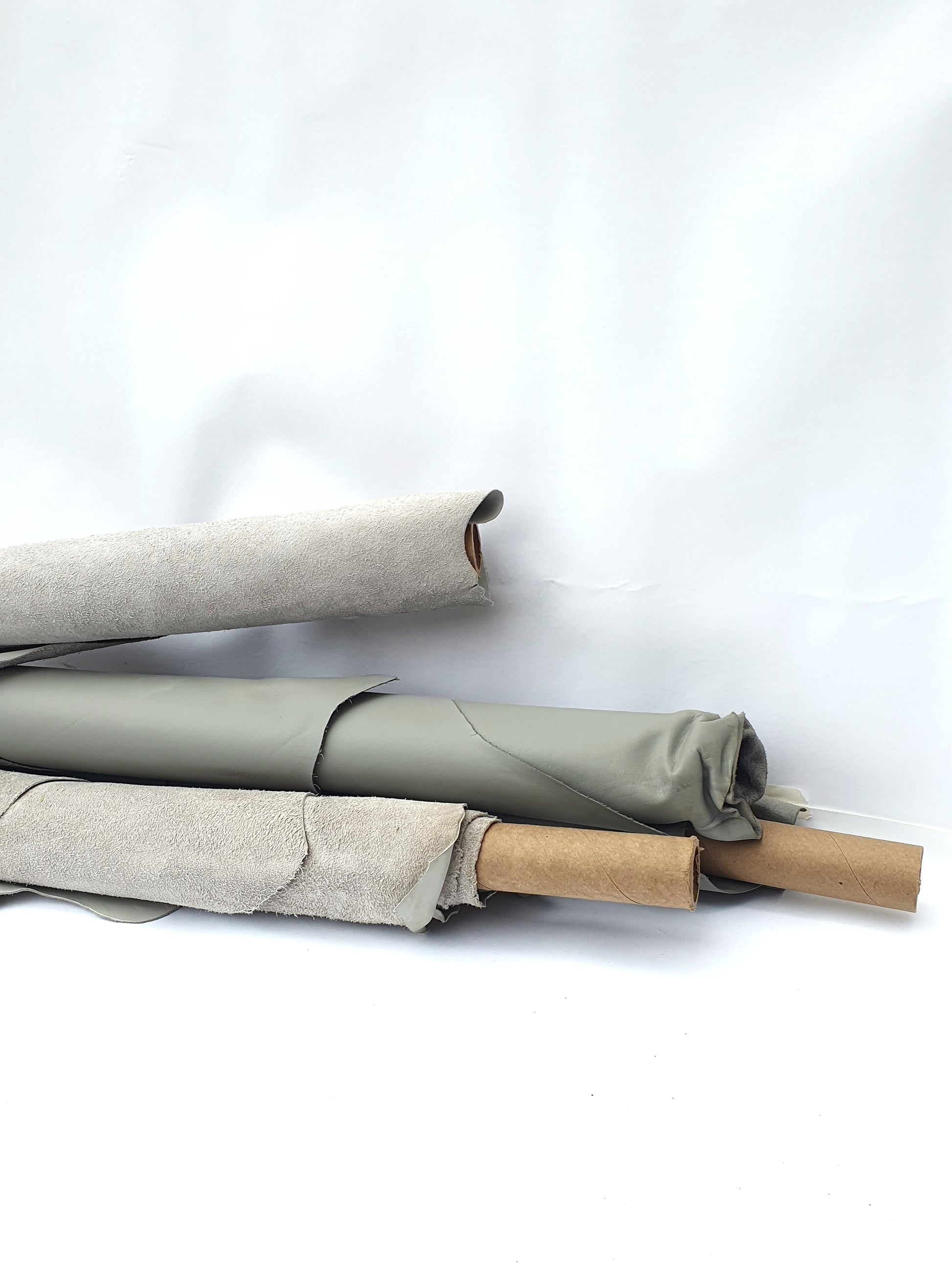 Collection of rolled up grey and light grey leather 