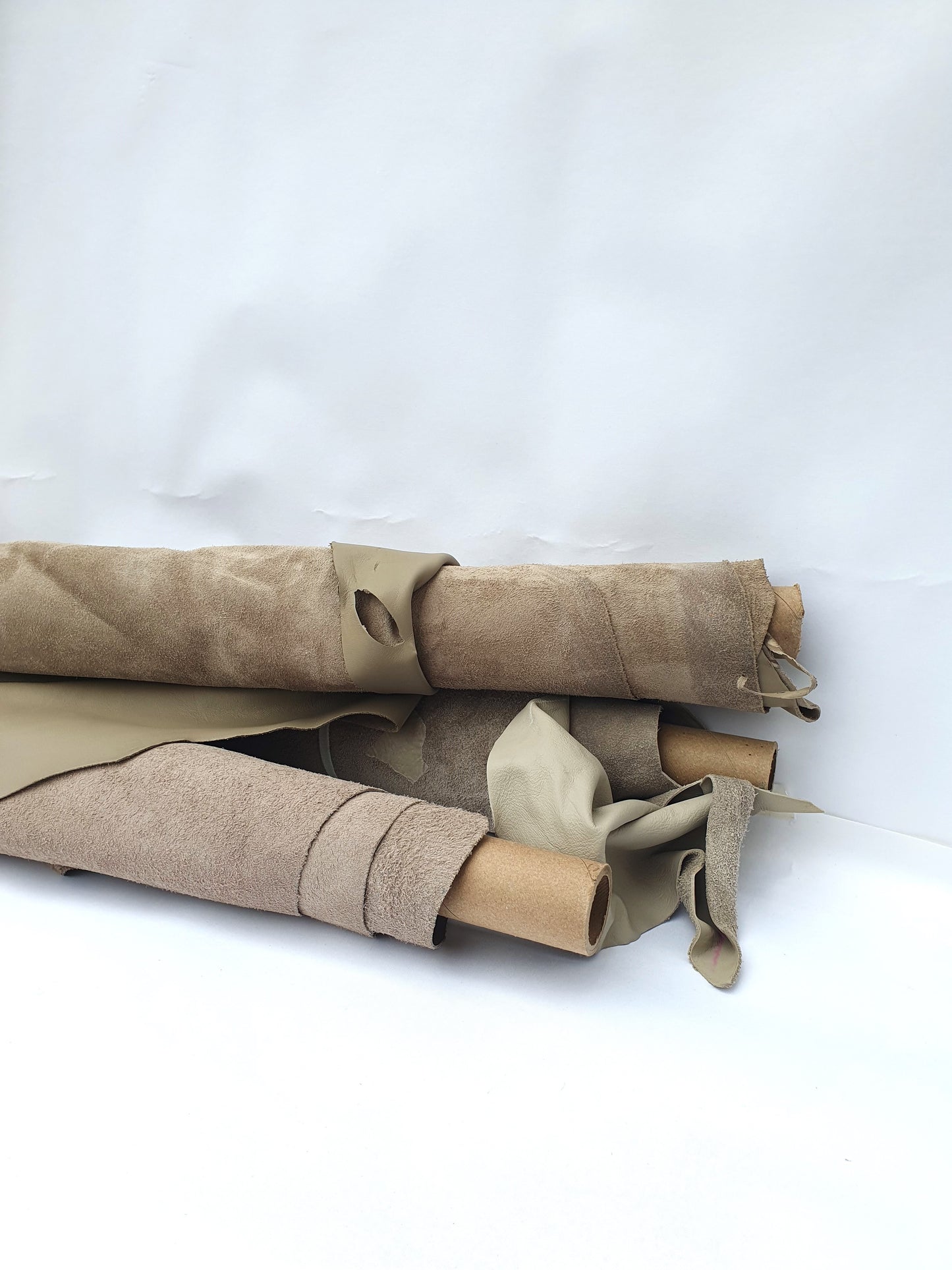 Collection of mushroom coloured rolled leather with partially holed
