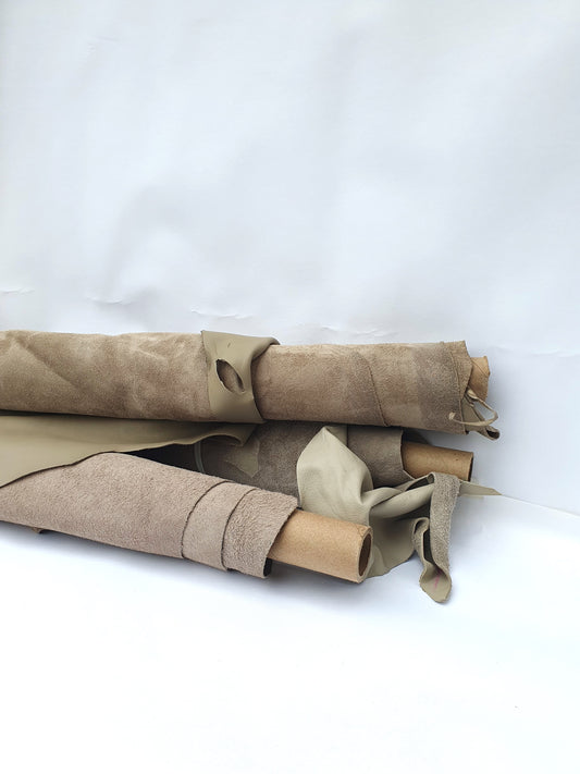 Collection of mushroom coloured rolled leather with partially holed