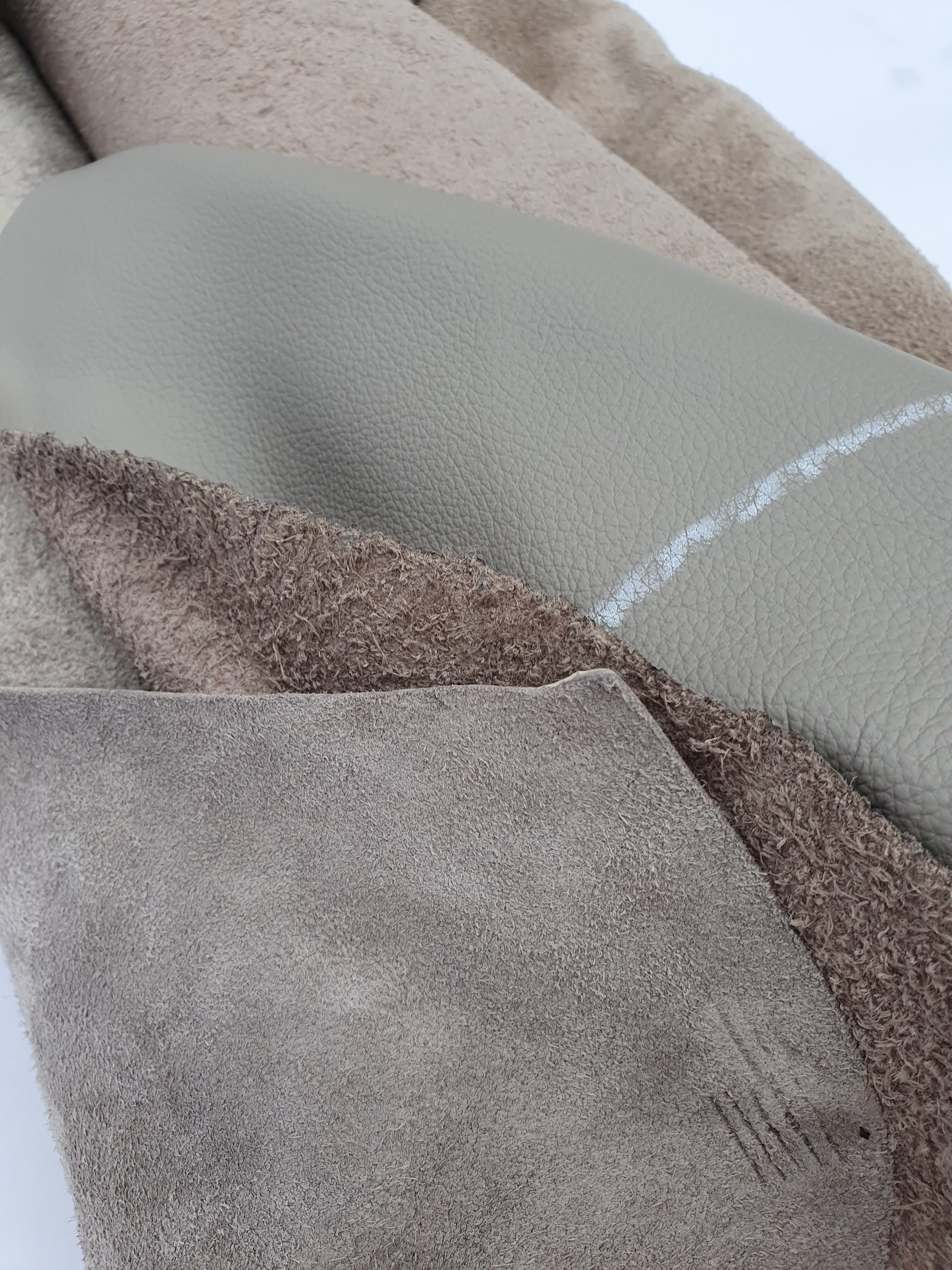 Collection of mushroom coloured rolled leather with visible marking lines 