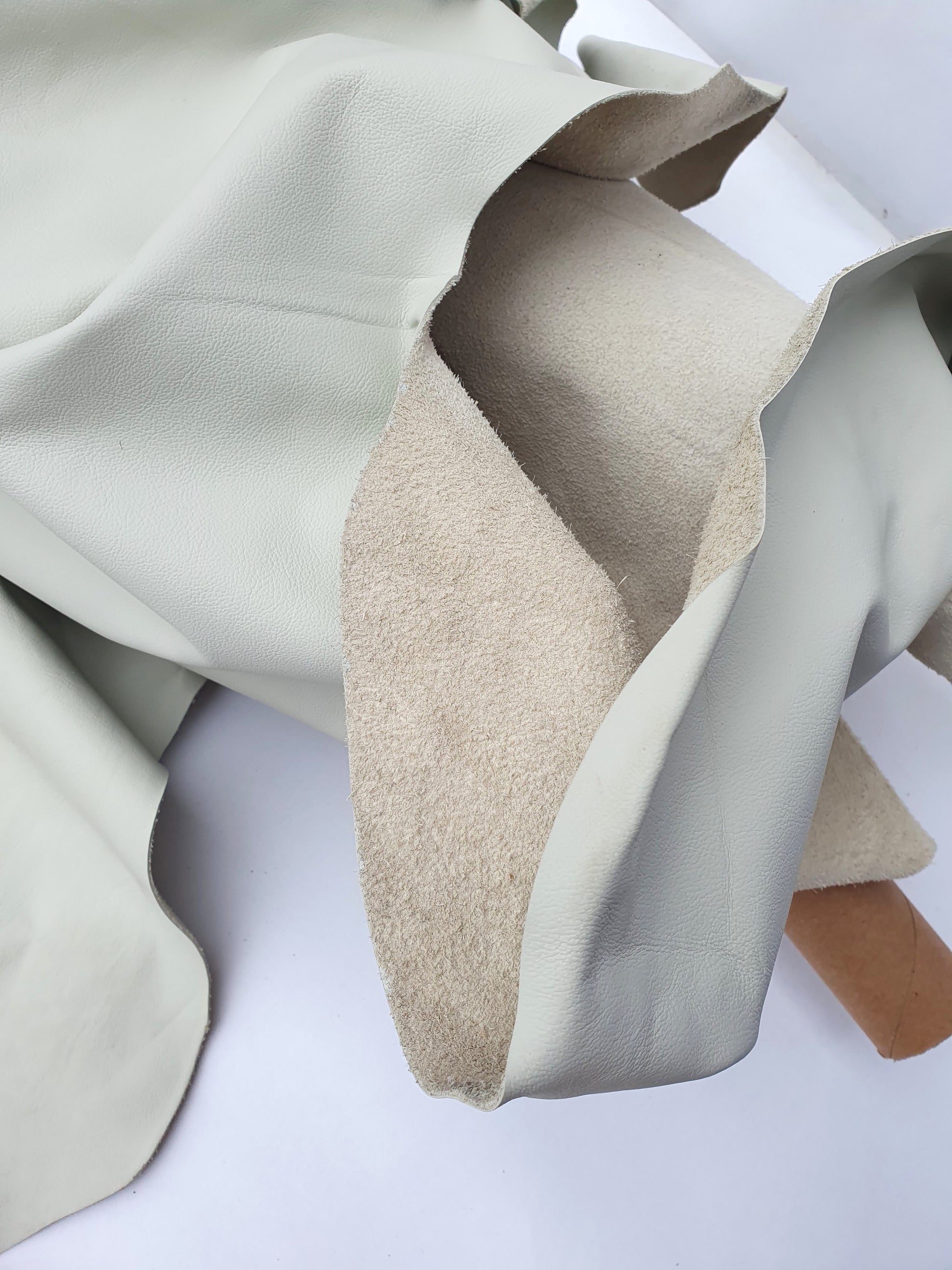 Rolled cream coloured leather, texture visible
