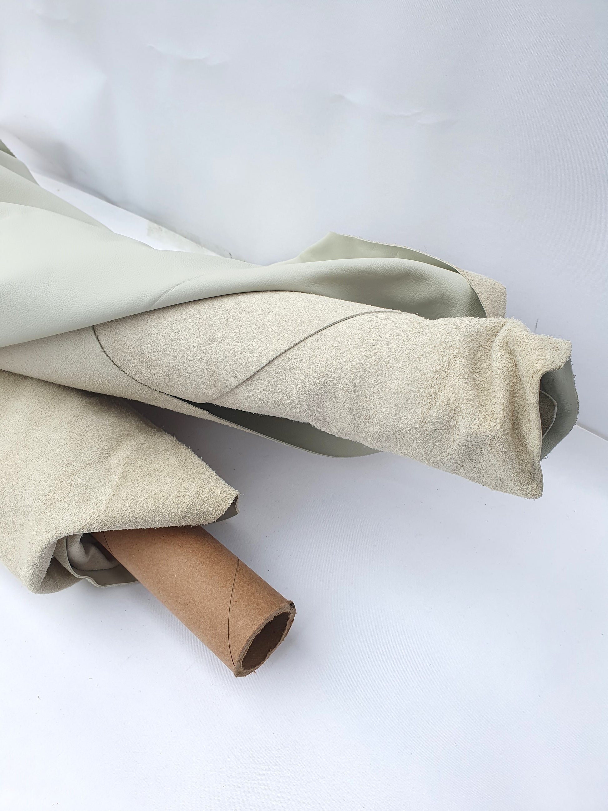 Two rolled cream coloured leather 