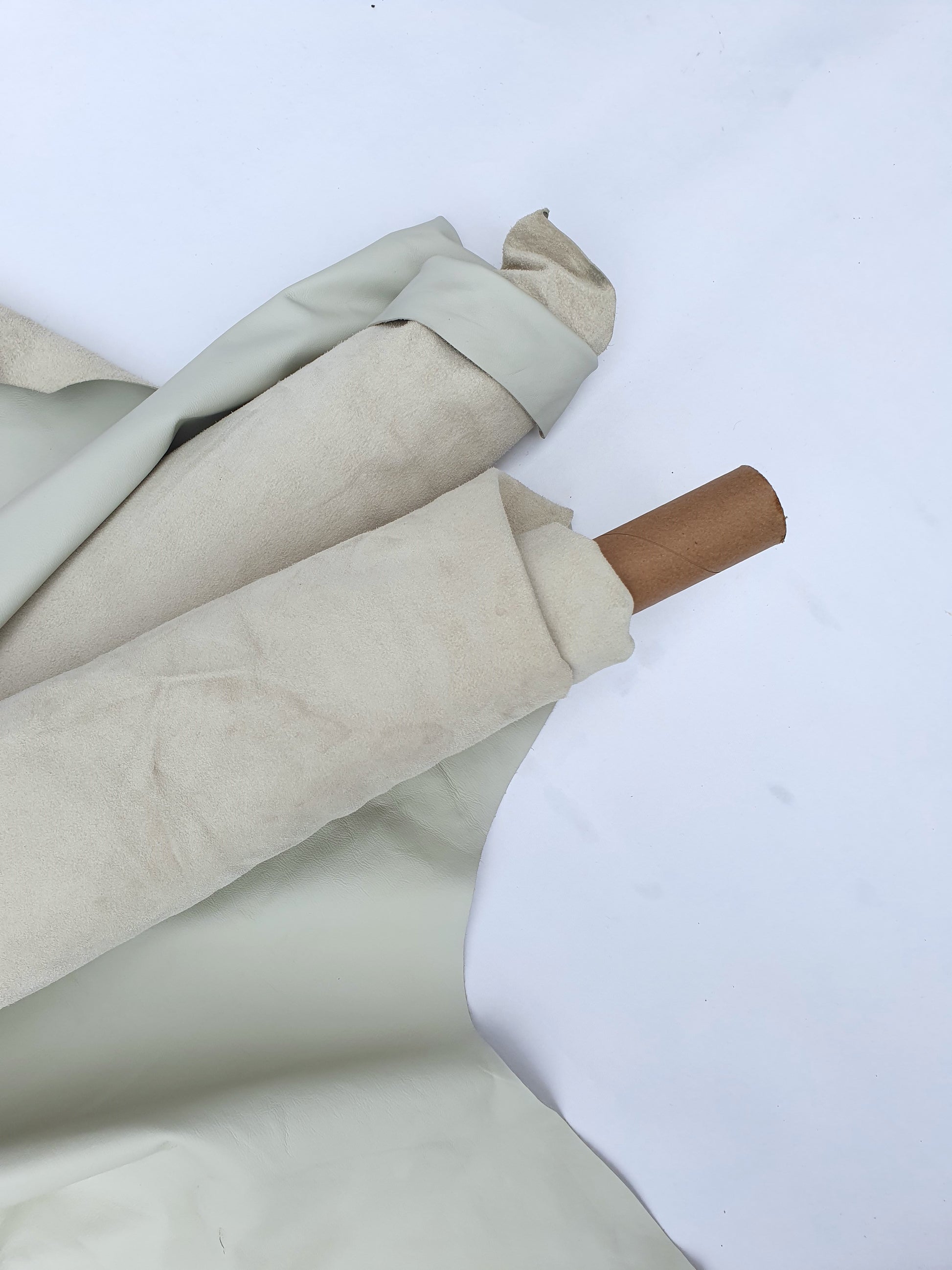 Two rolled cream coloured leather with some stains
