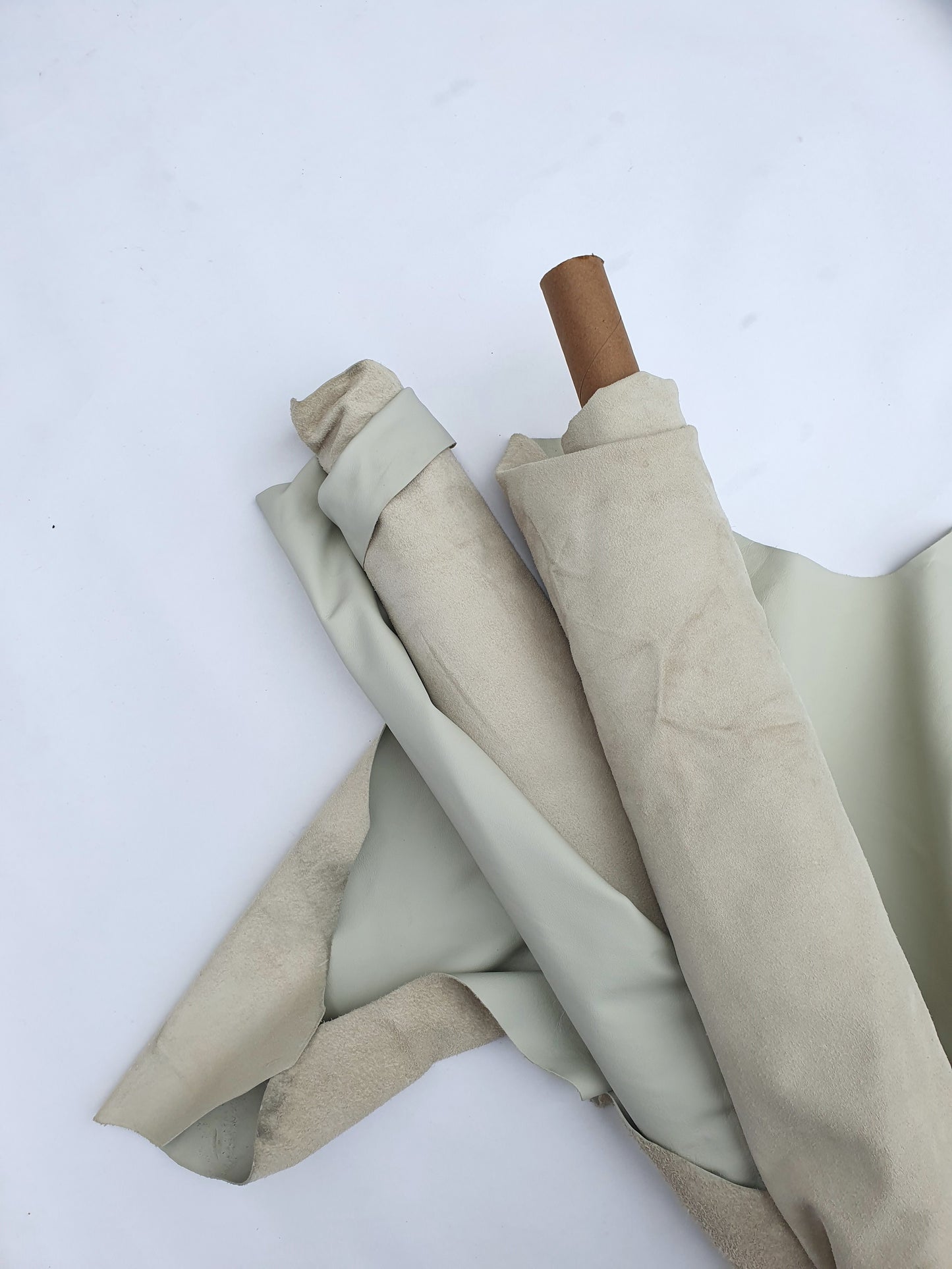 Two rolled cream coloured leather with some stains