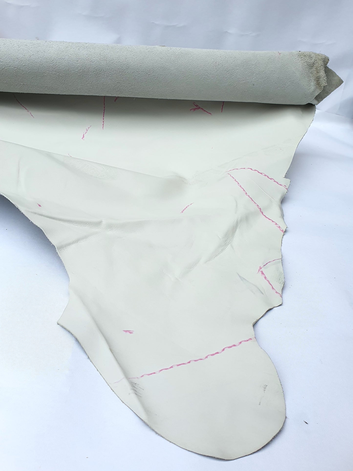 White leather with visible markings and a rough texture