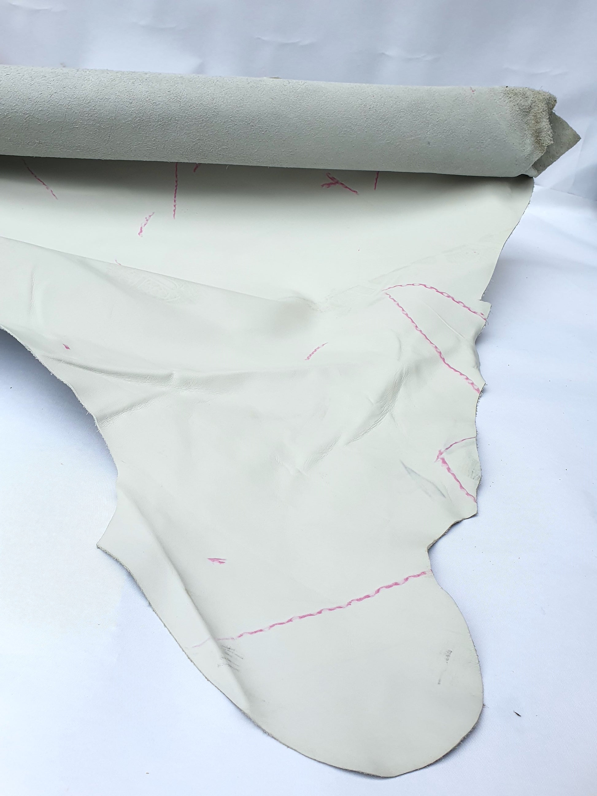 White leather with visible markings and a rough texture