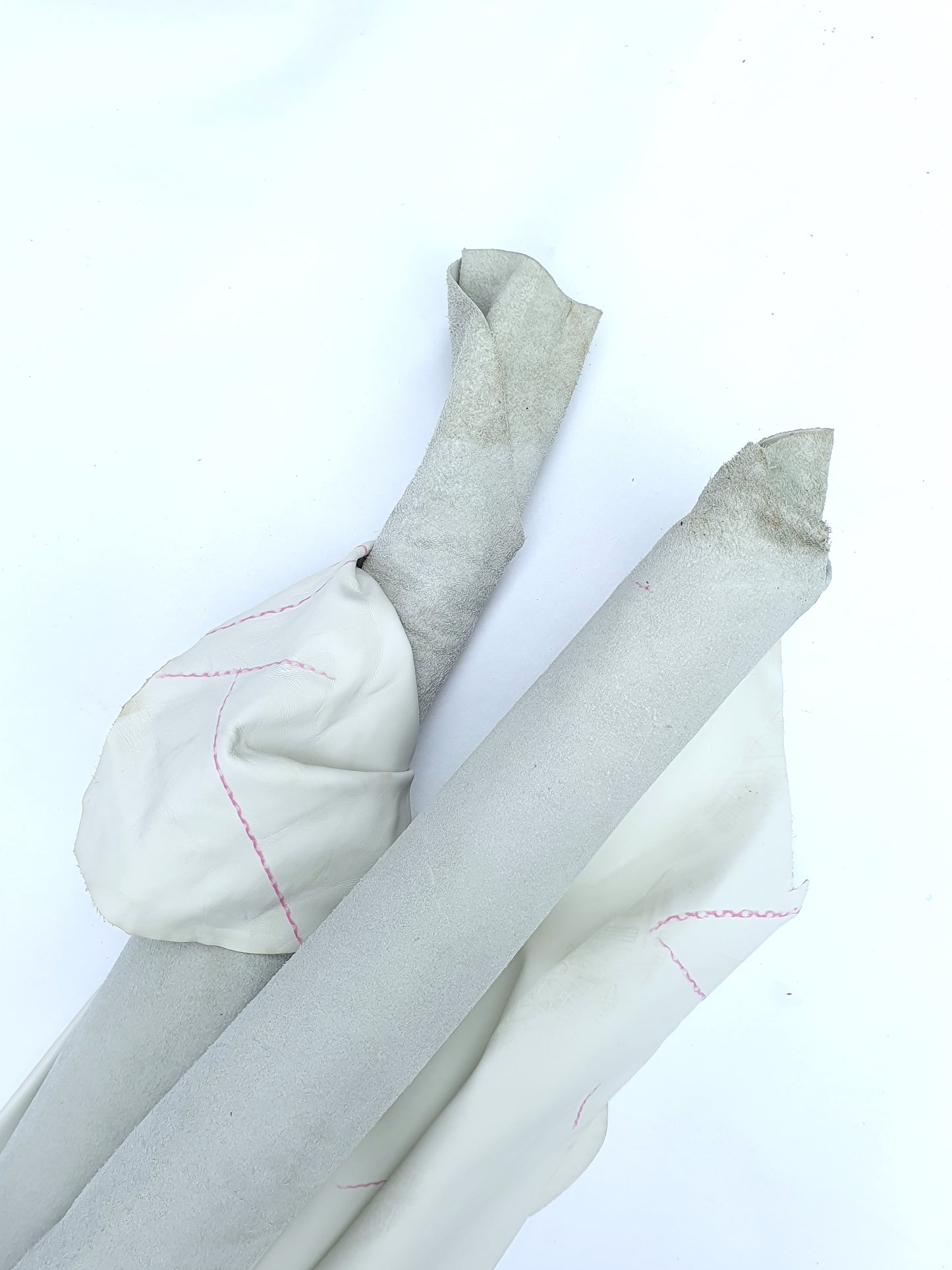 White rolled leather with red marks lines 