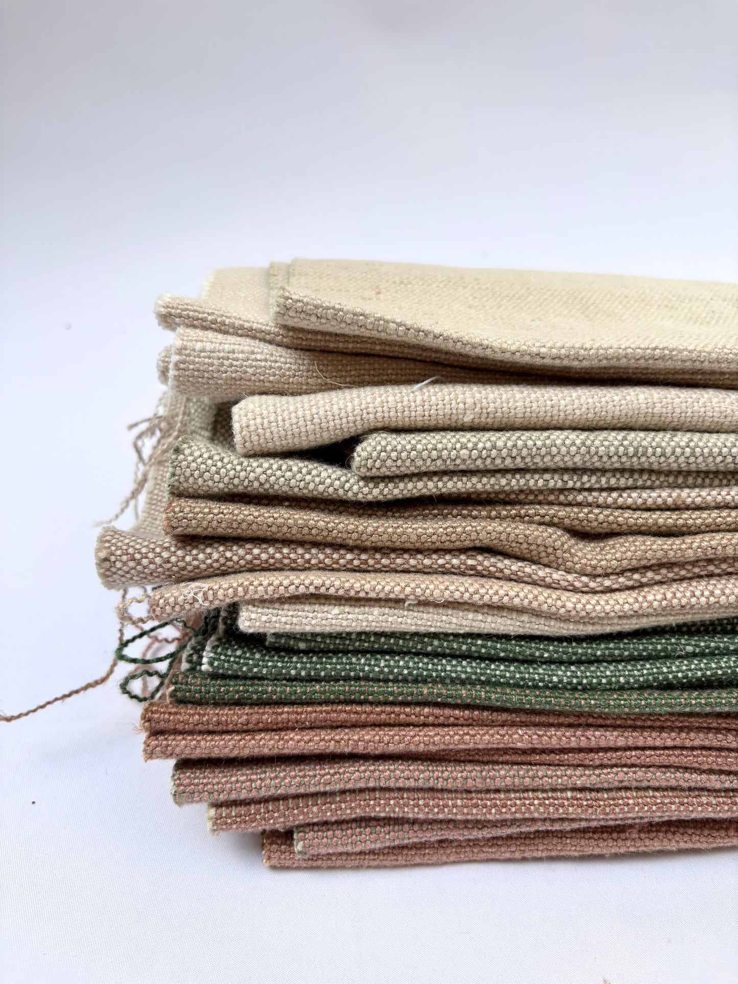 Stack of linen fabric swatches in various colours 