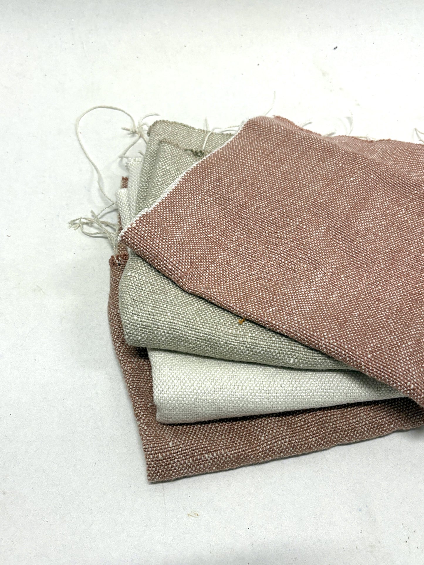 Stack of linen fabric swatches in various colours 